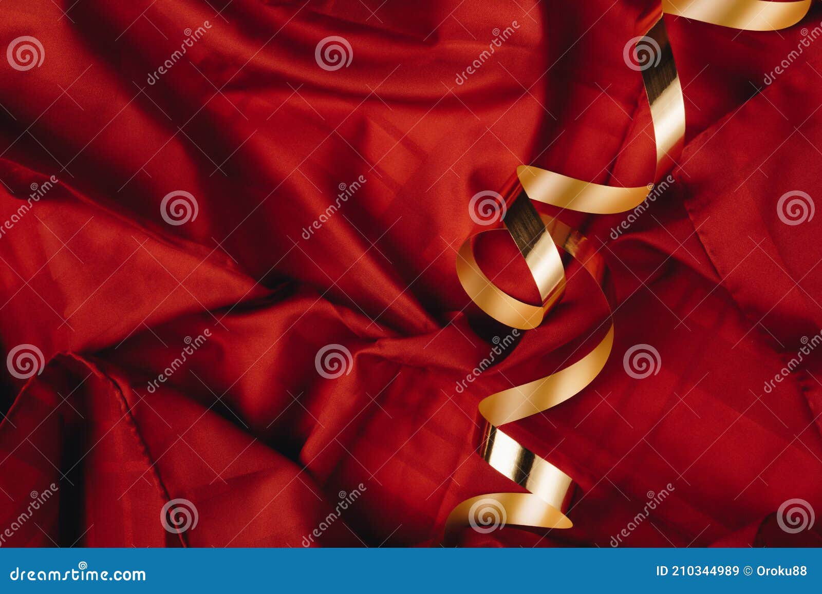 abstract concept art of red silk or saten background with golden ribbon. party or birthday idea with copy space