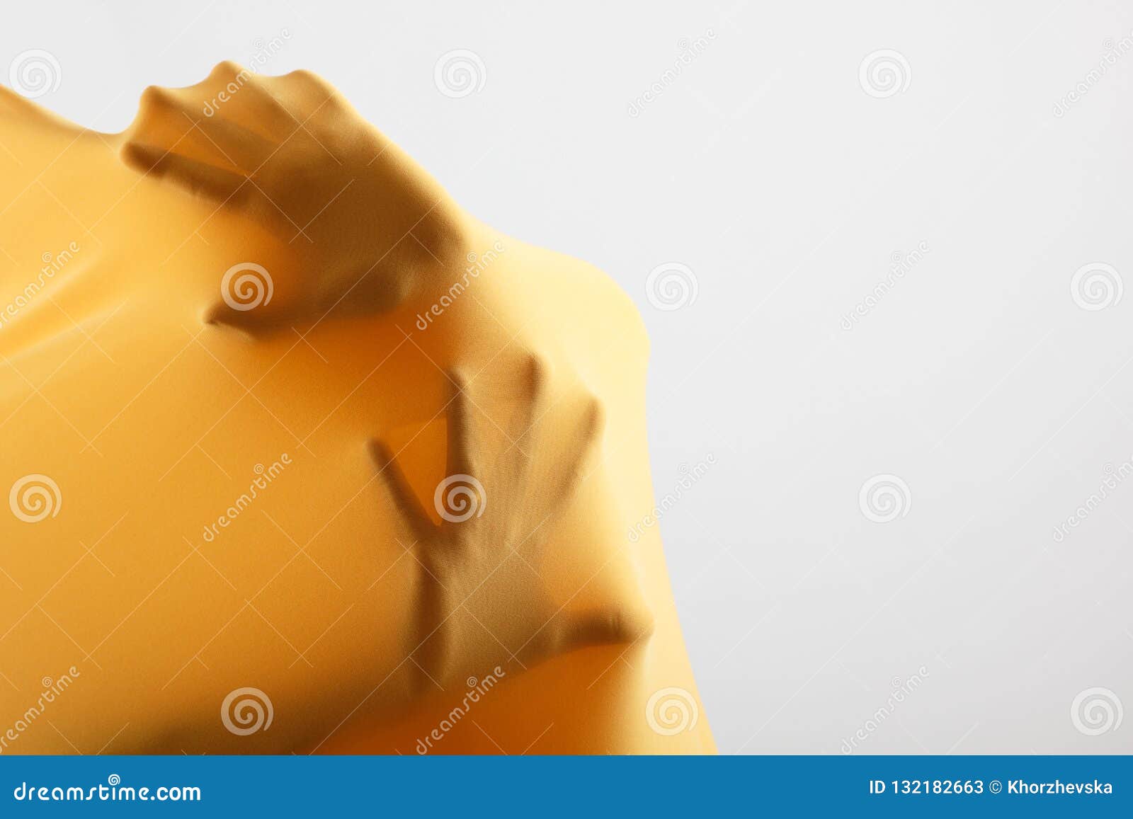 abstract hands, human arm inside yellow fabric