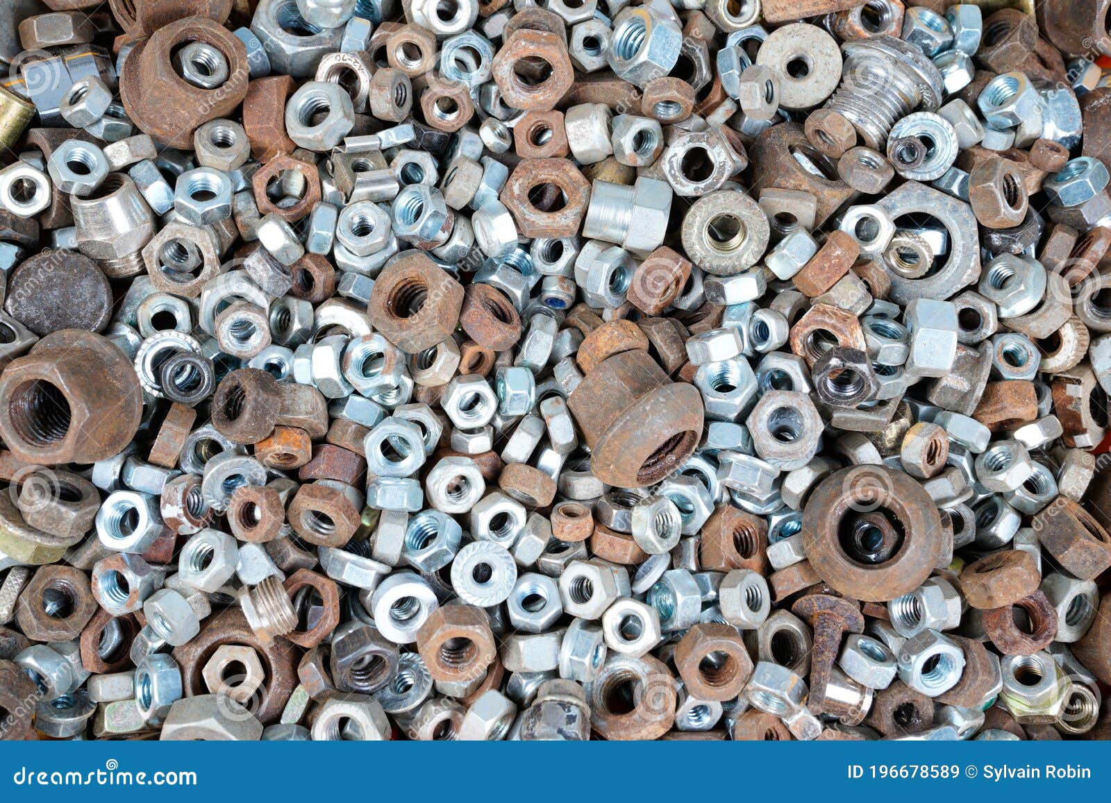 abstract industrial old background with rusty used nuts for wallpaper many metalware