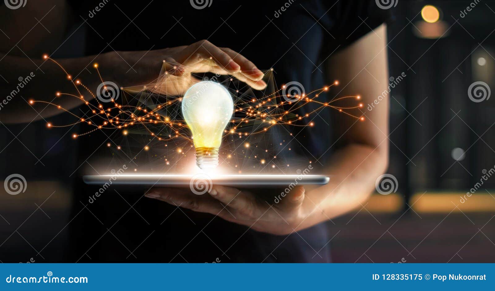 abstract. innovation. hands holding tablet with light bulb future