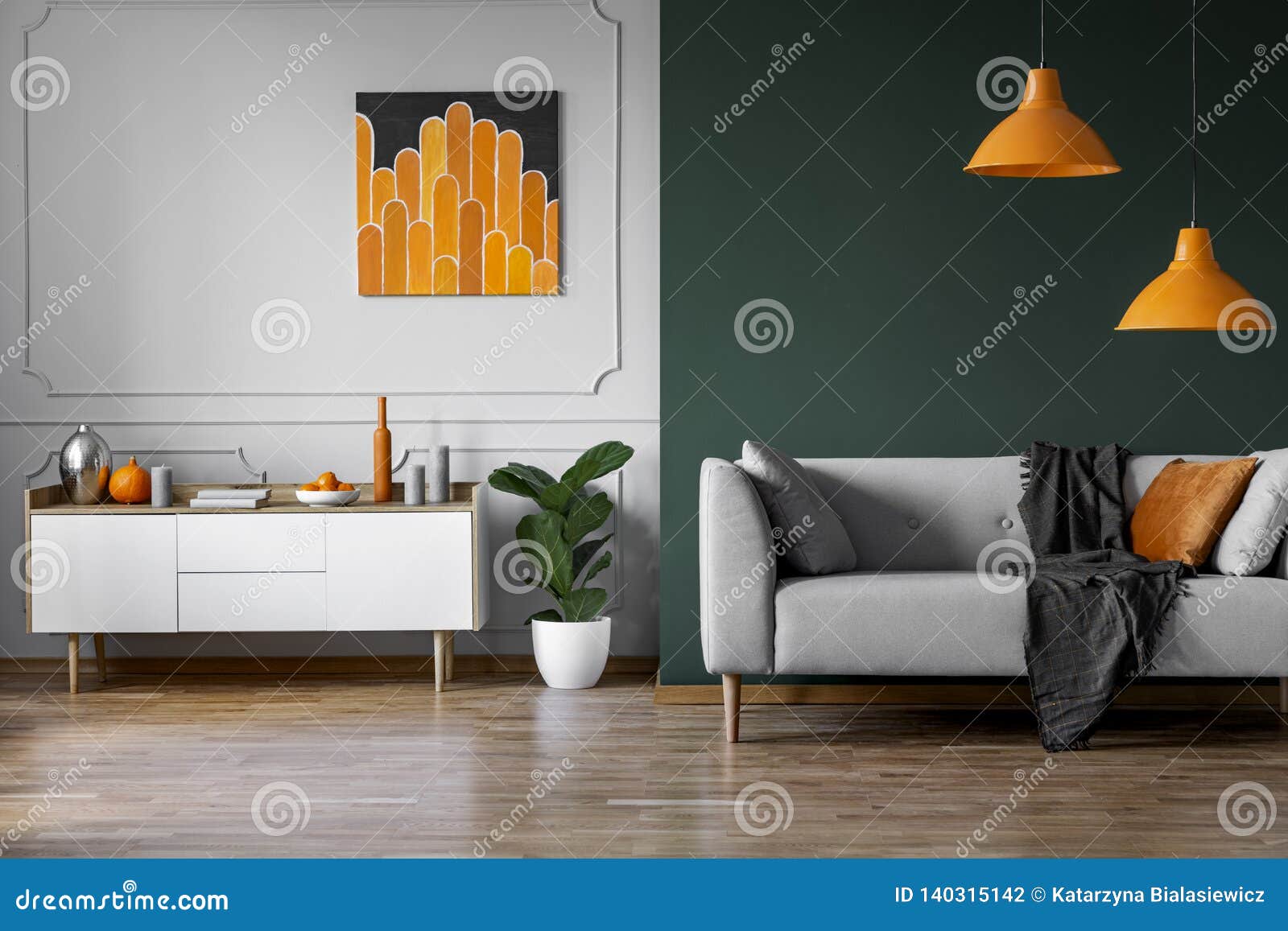 abstract orange painting on grey wall of stylish living room interior with white wooden furniture and grey couch