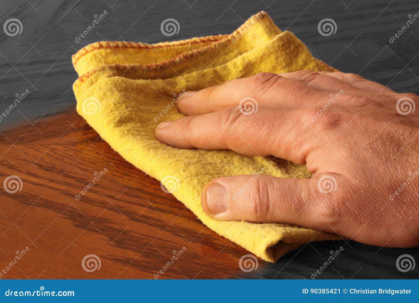 Abstract Selective Colour Image of a Man Polishing a Wooden Table Stock