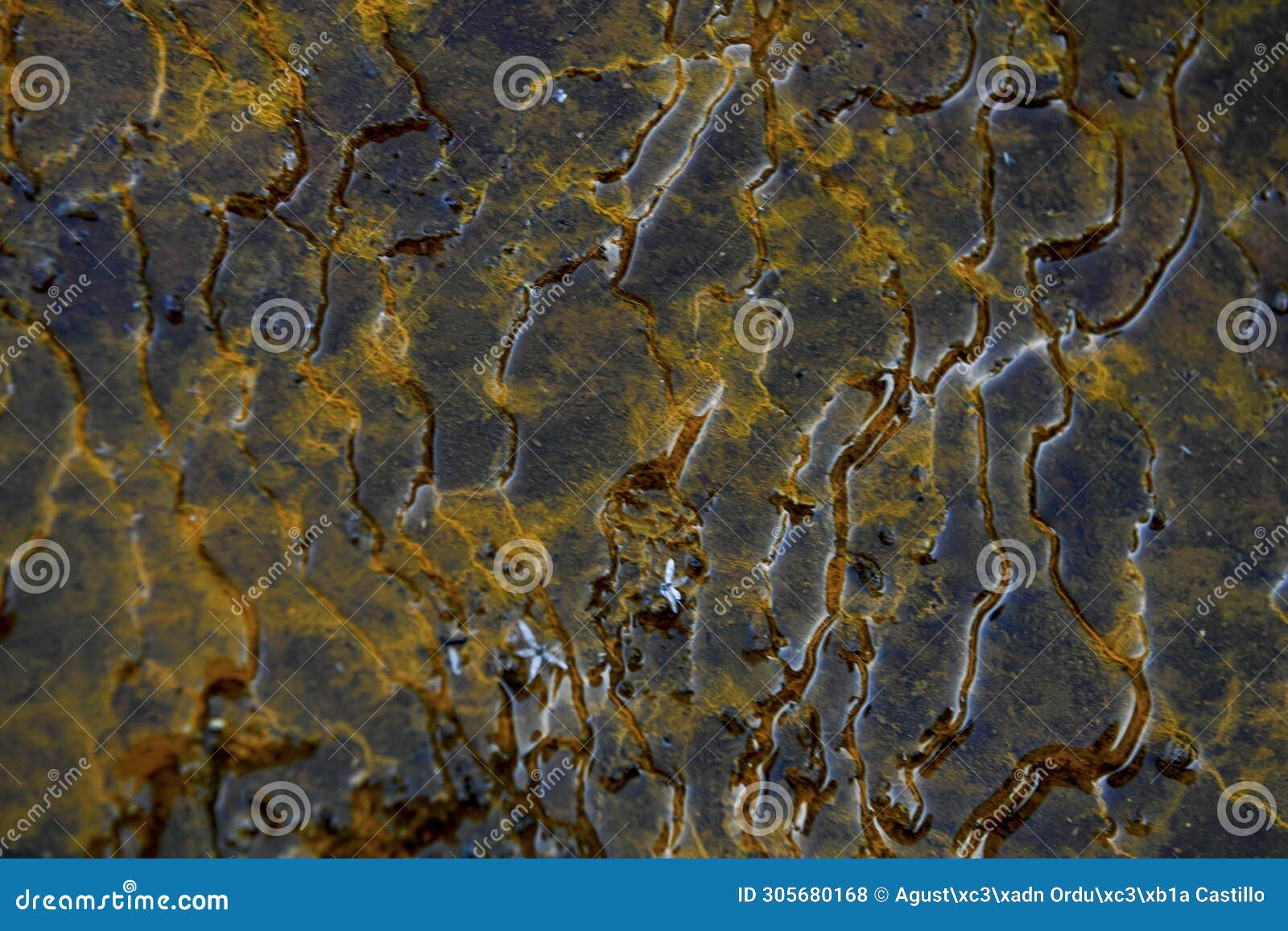 abstract water channels in mineral-rich rio tinto