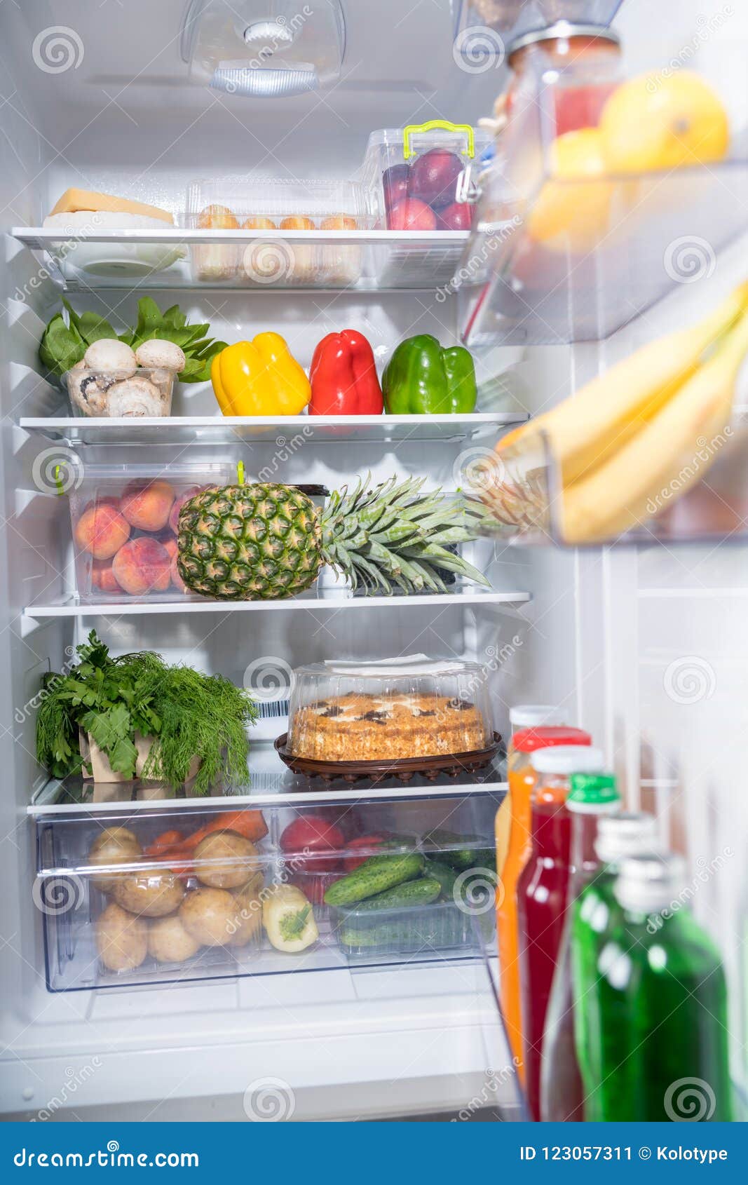 Fresh food abundance in open fridge. Abundance of fresh food products in open refrigerator.