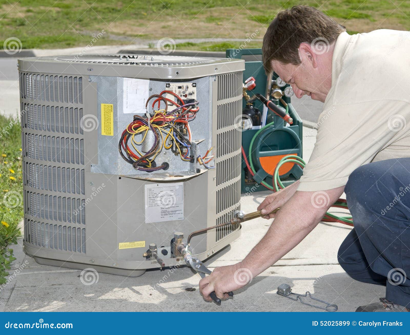 AC Repairman Welds Connector on Replacement Air Conditioning Unit Stock