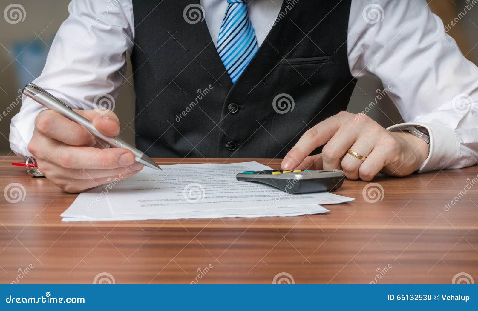 accountant or business man is calculating taxes with calculator