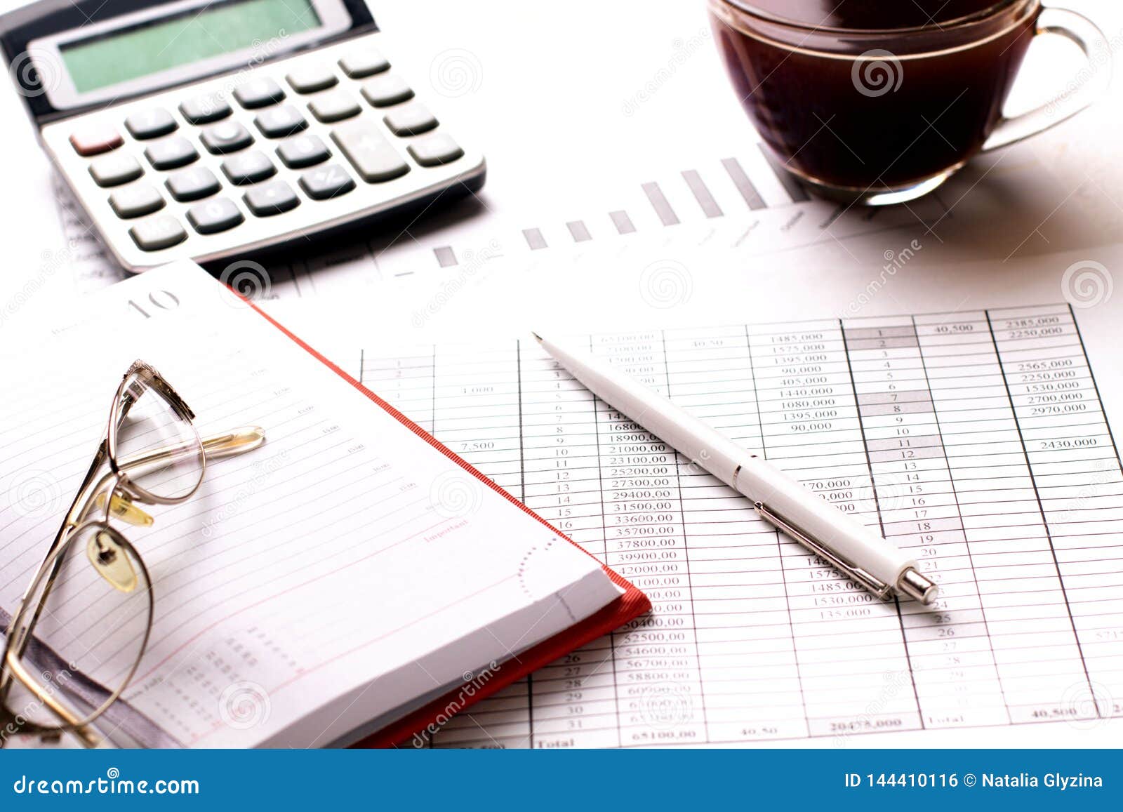 Accountant Work Table with Calculator, Charts and Pen Stock Photo