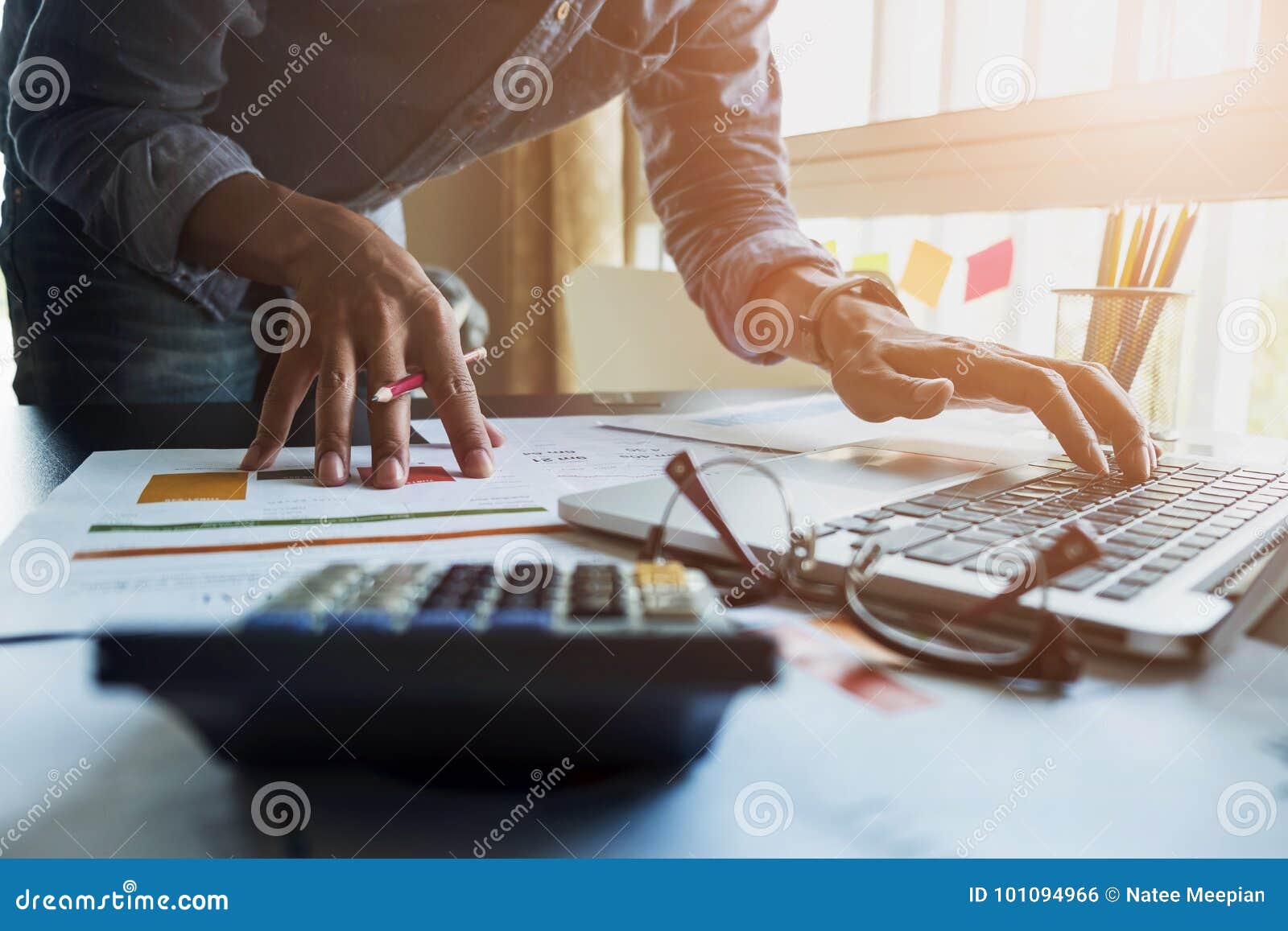accountants work analyzing financial reports on a laptop at his
