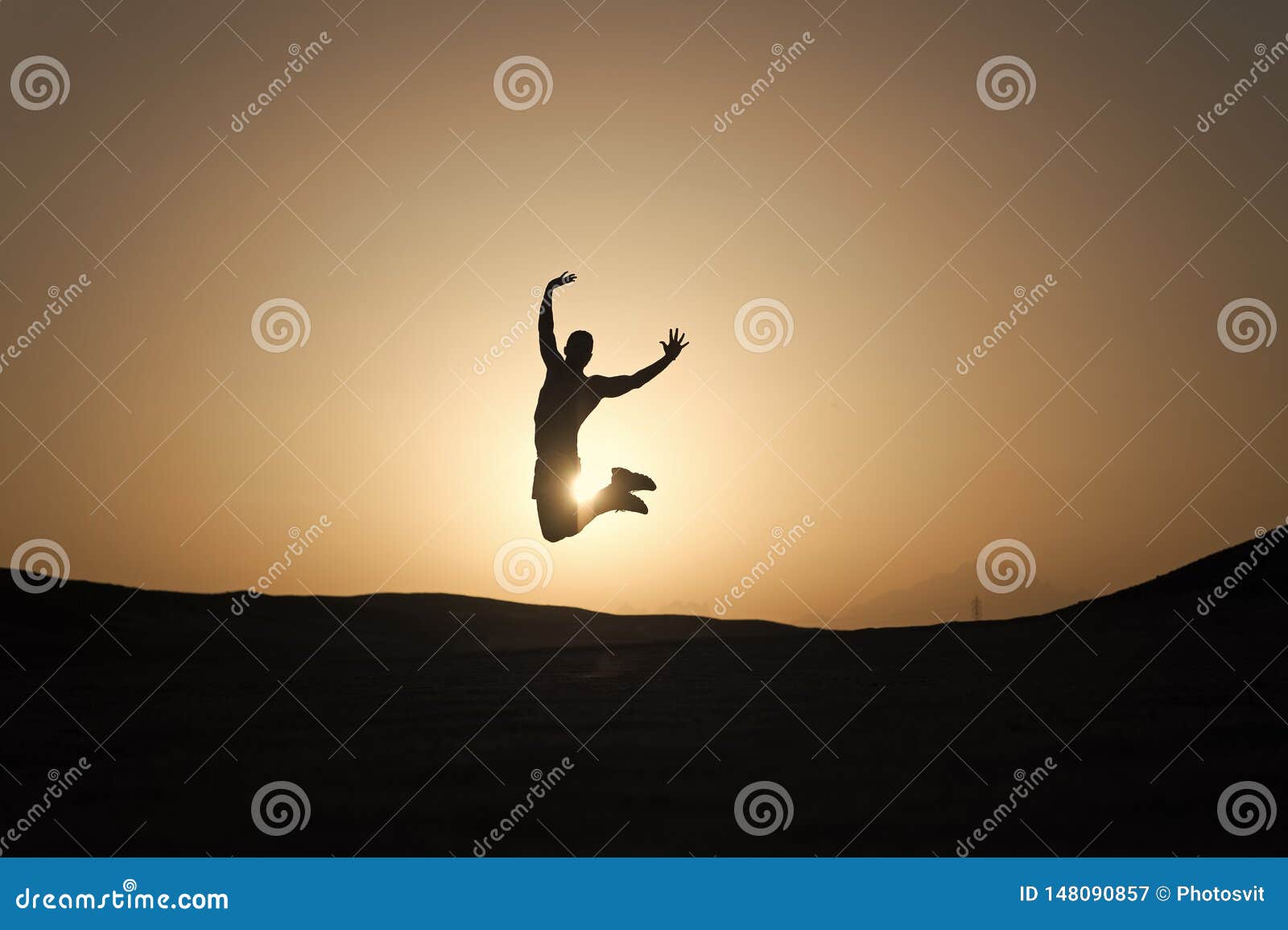 achieve main goal. silhouette man motion jump in front of sunset sky background. future success depends on your efforts