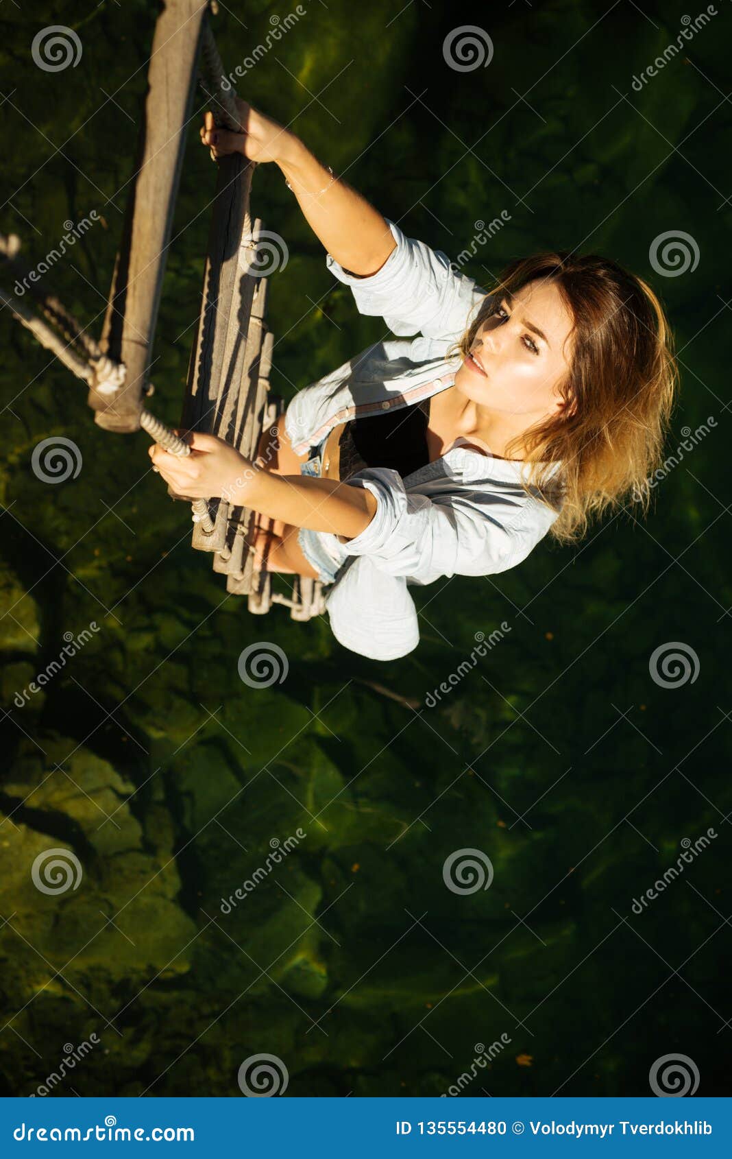 Achieving Her Towering Ambition Woman Climbing Up Rope Ladder Stock