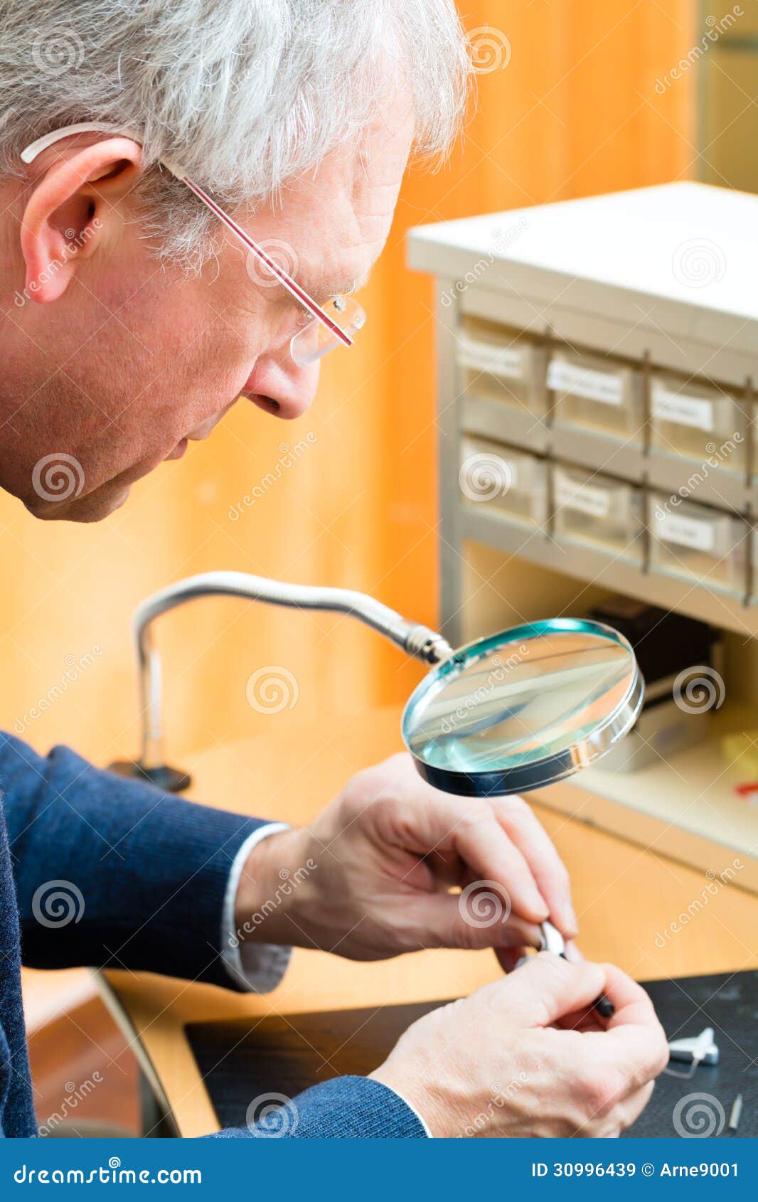 Acoustician Working on a Hearing Aid Stock Image Image of magnifying, adjust 30996439