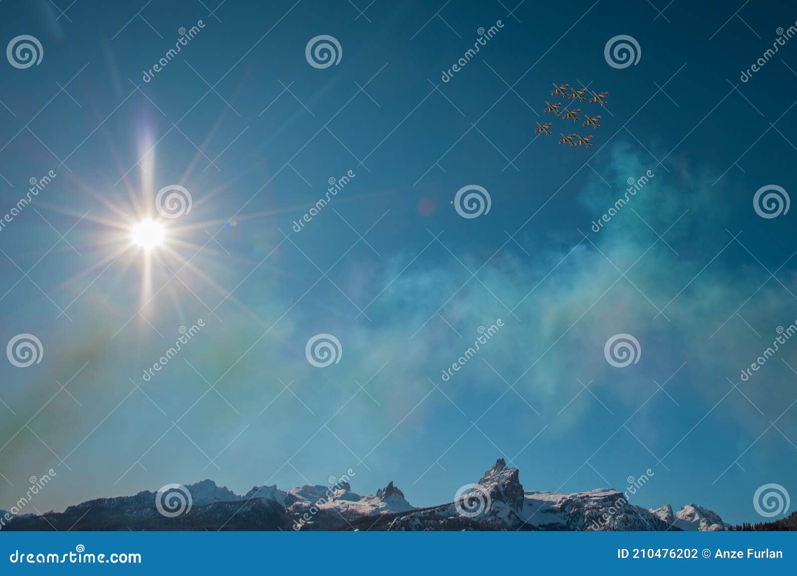 acrobatic group of freccia trecolori jet aeroplanes are performing maneouvres in a formation in the italian dolomites close to