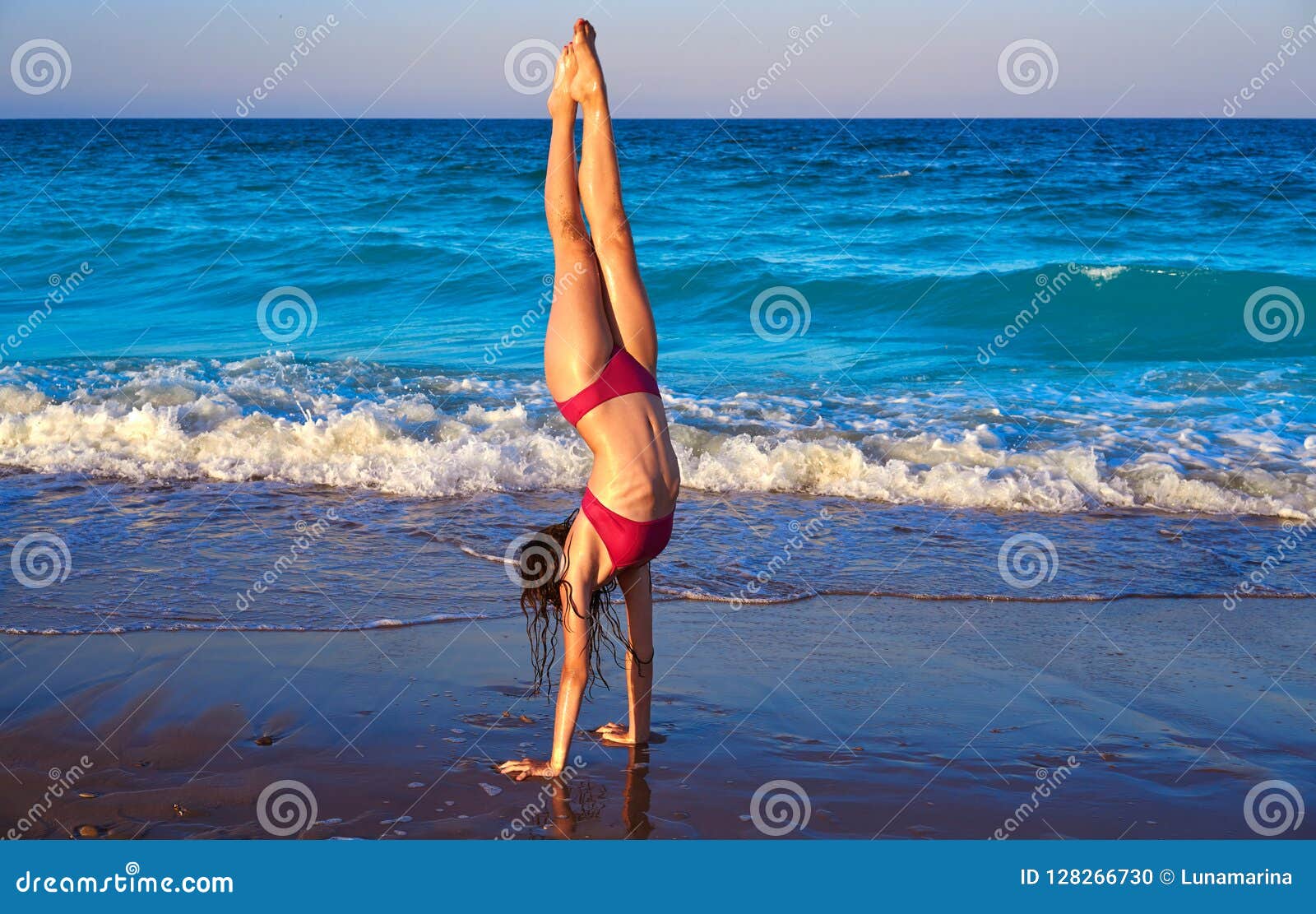 acrobatic gymnastics bikini girl in a beach