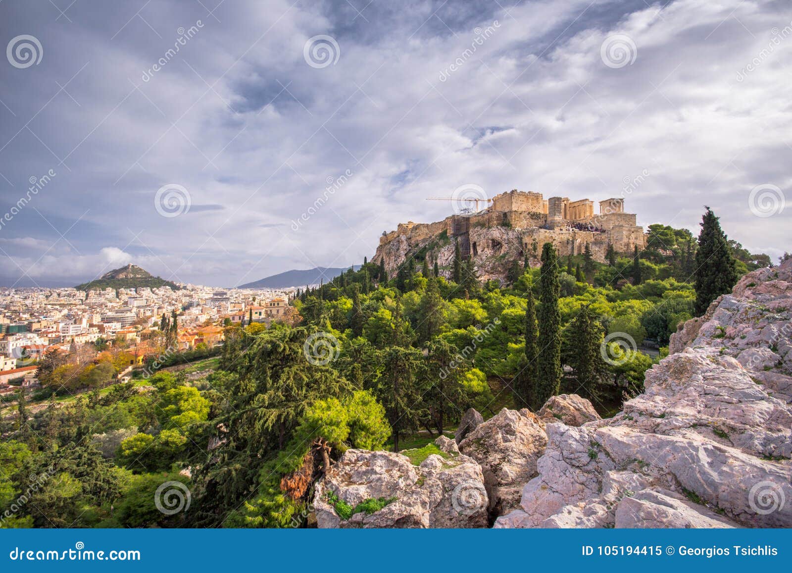 acropolis with parthenon with the hill of lycabetus and nice clouds.