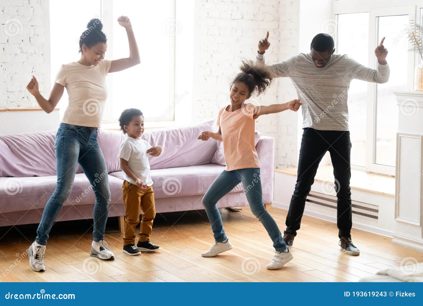 active black family with children dancing at home