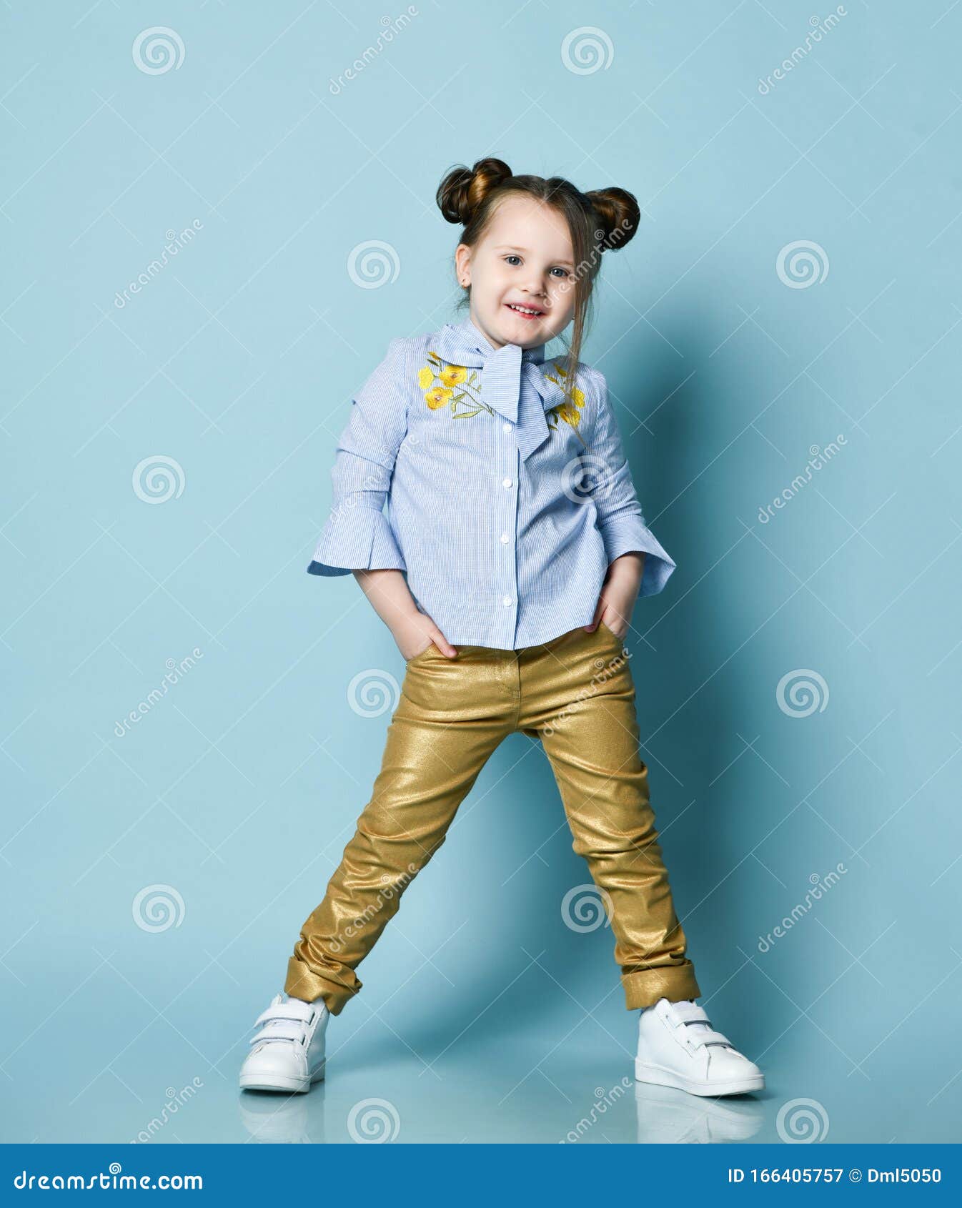 Active Cheerful Baby Kid Girl in Blue Shirt and Gold Leather Pants is ...