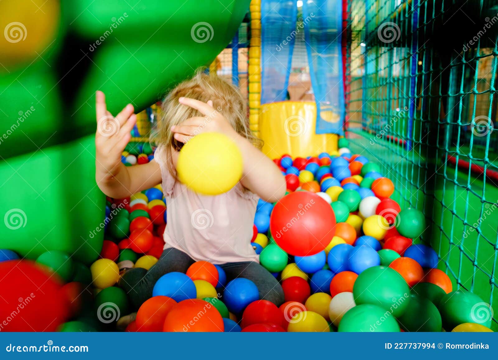 Active Little Girl Playing in Indoor Playground. Happy Joyful Preschool