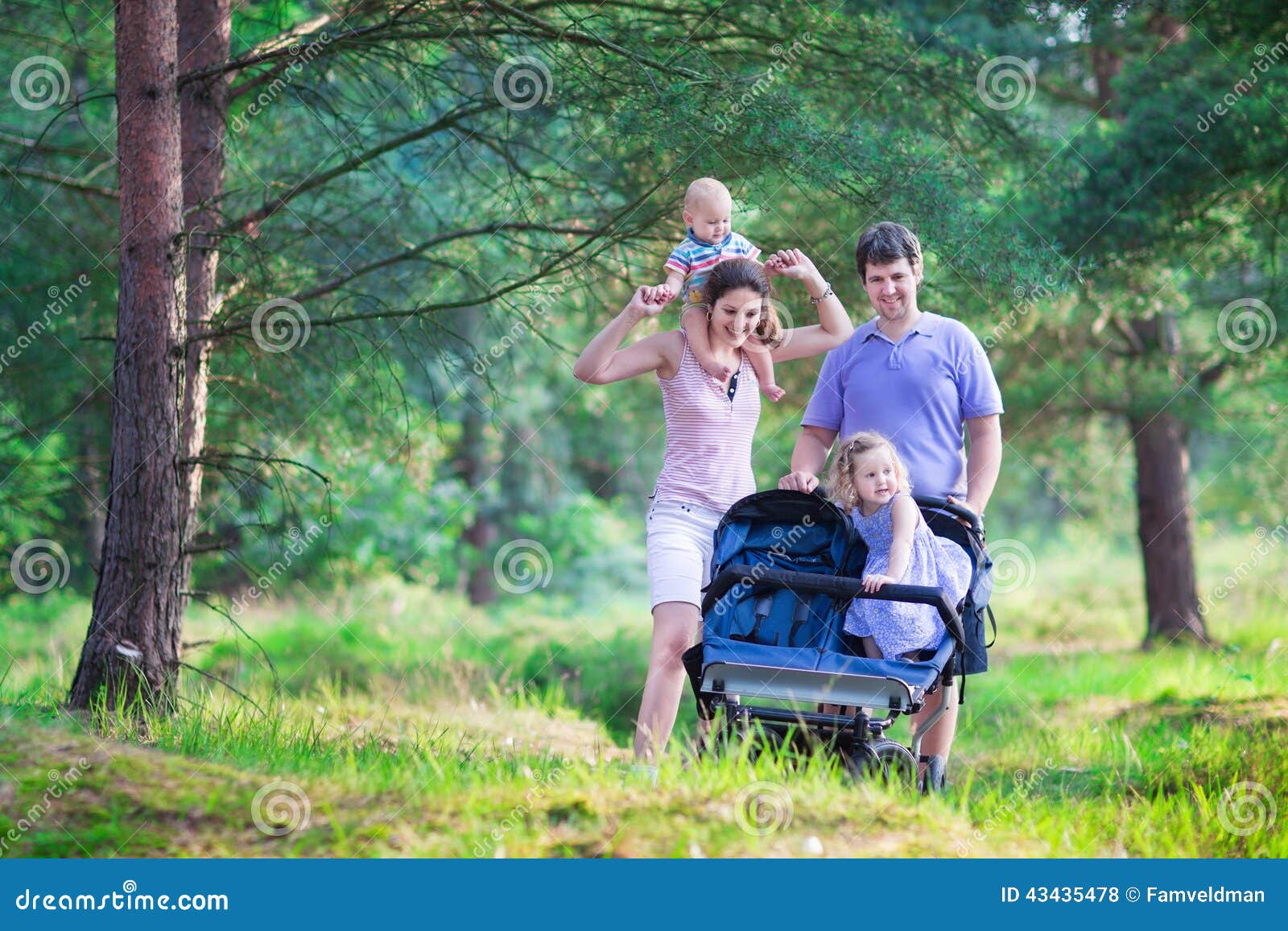active parent hiking two kids stroller family young parents their little children adorable toddler girl cute 43435478
