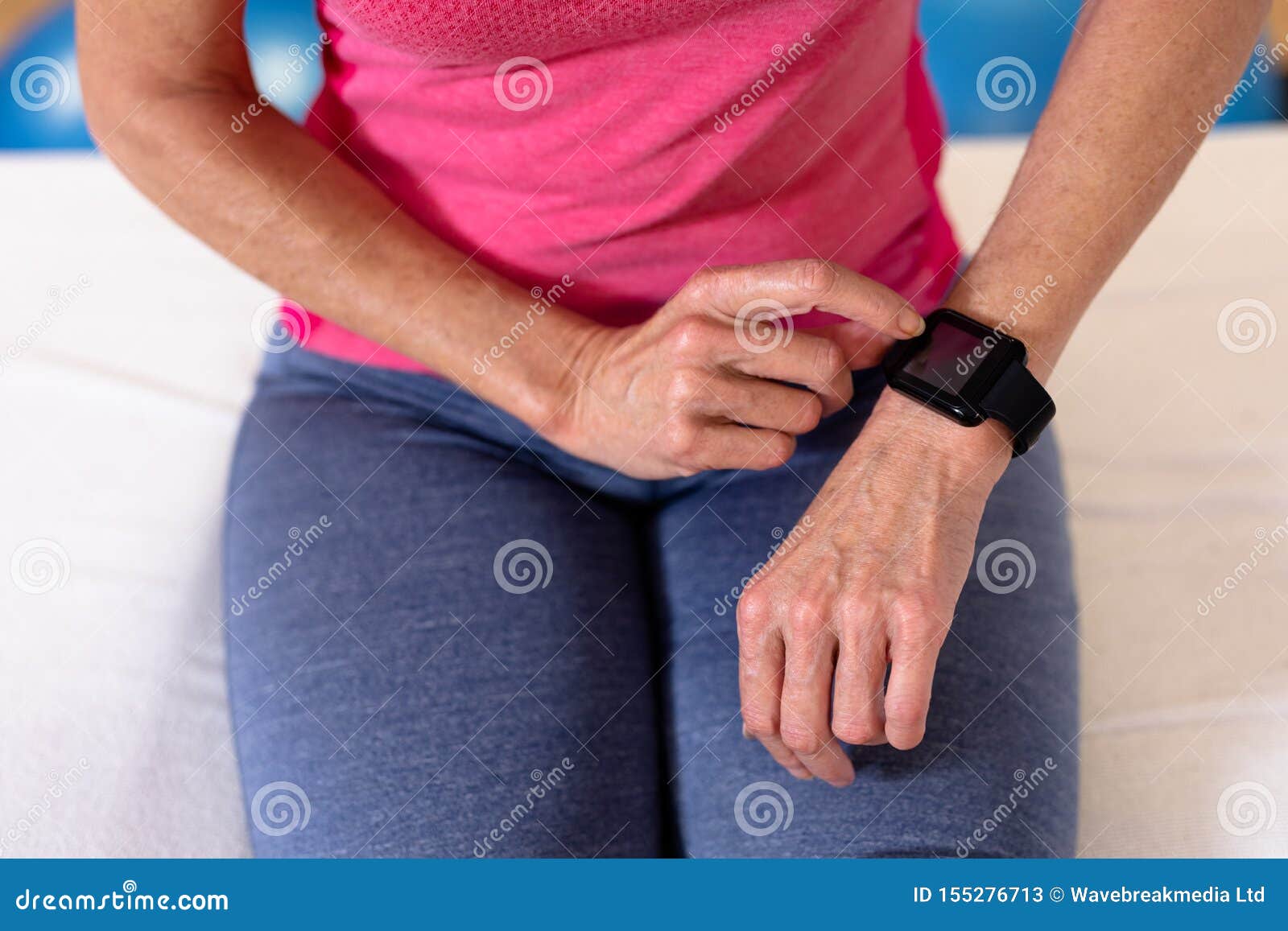 Active Senior Woman Using Smartwatch in Sports Center Stock Image