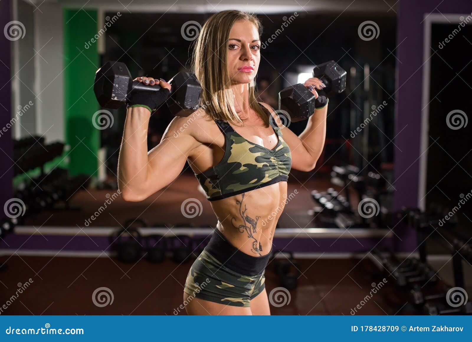 Active Sportive Athletic Woman With Dumbbells Pumping Up Muscles Biceps