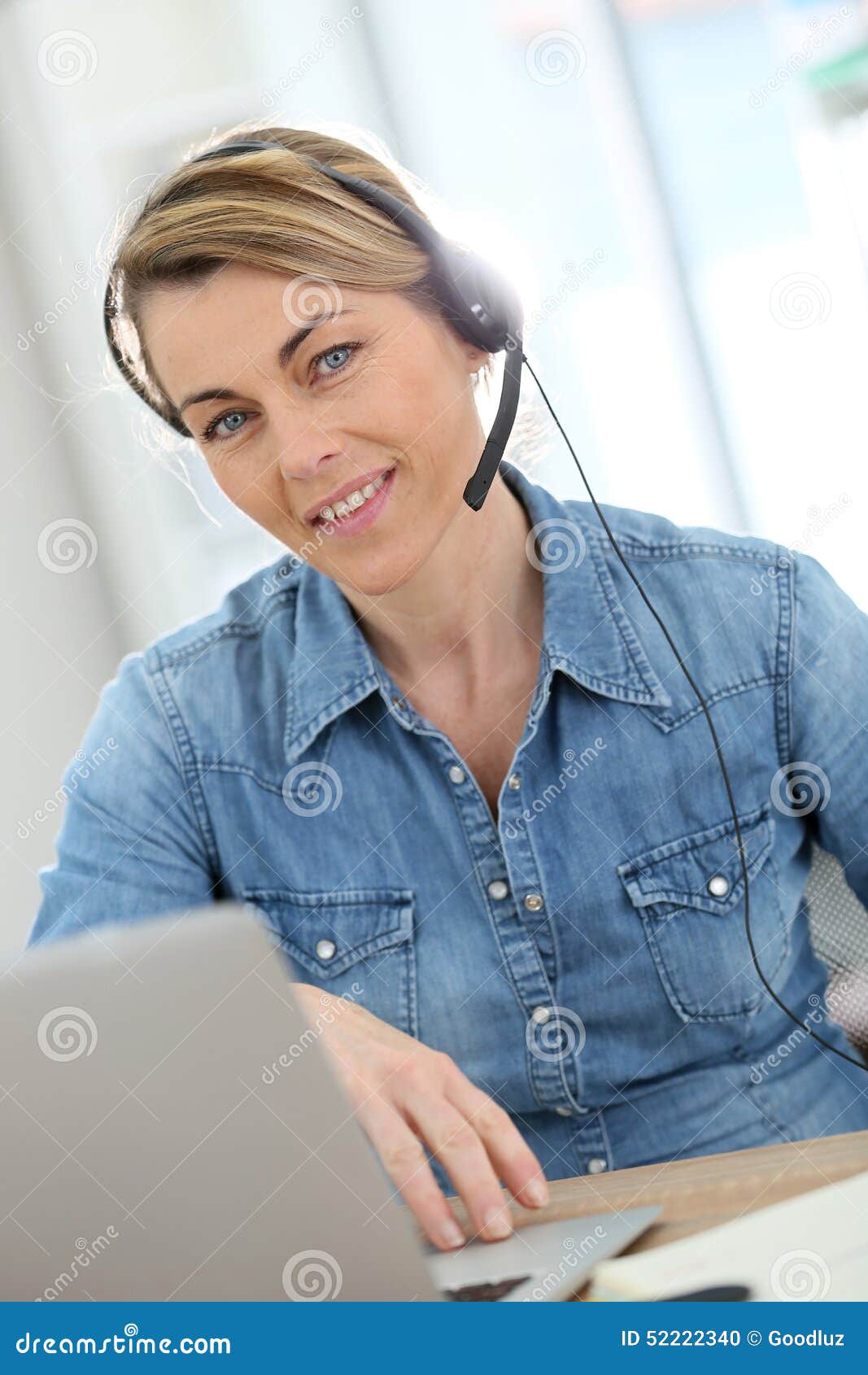 active woman teleworking from home with headphones
