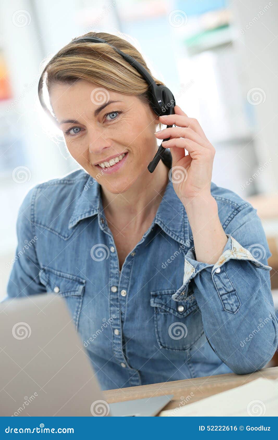 active woman teleworking from home using headphones