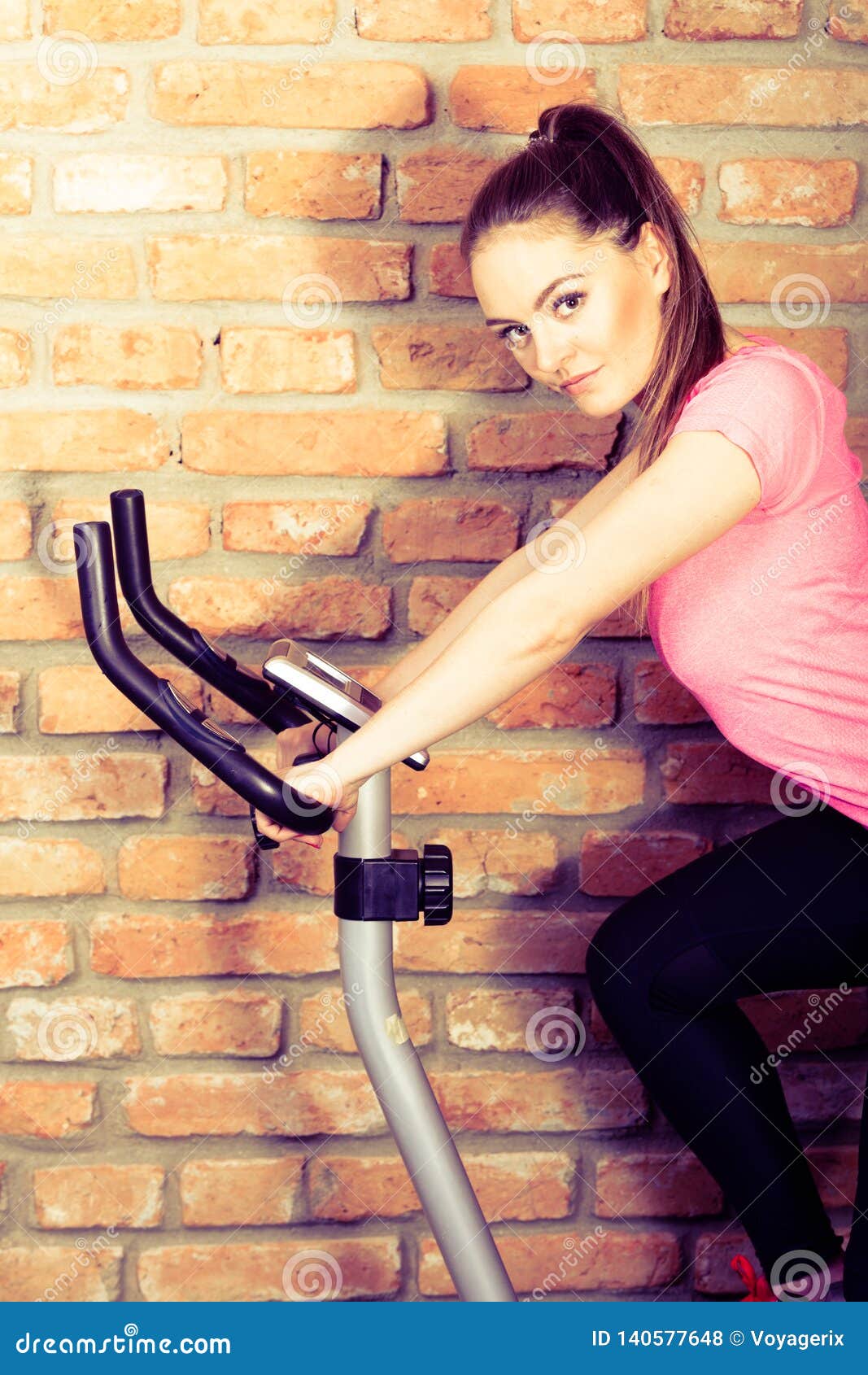 Women on exercise bikes. stock photo. Image of indoors 