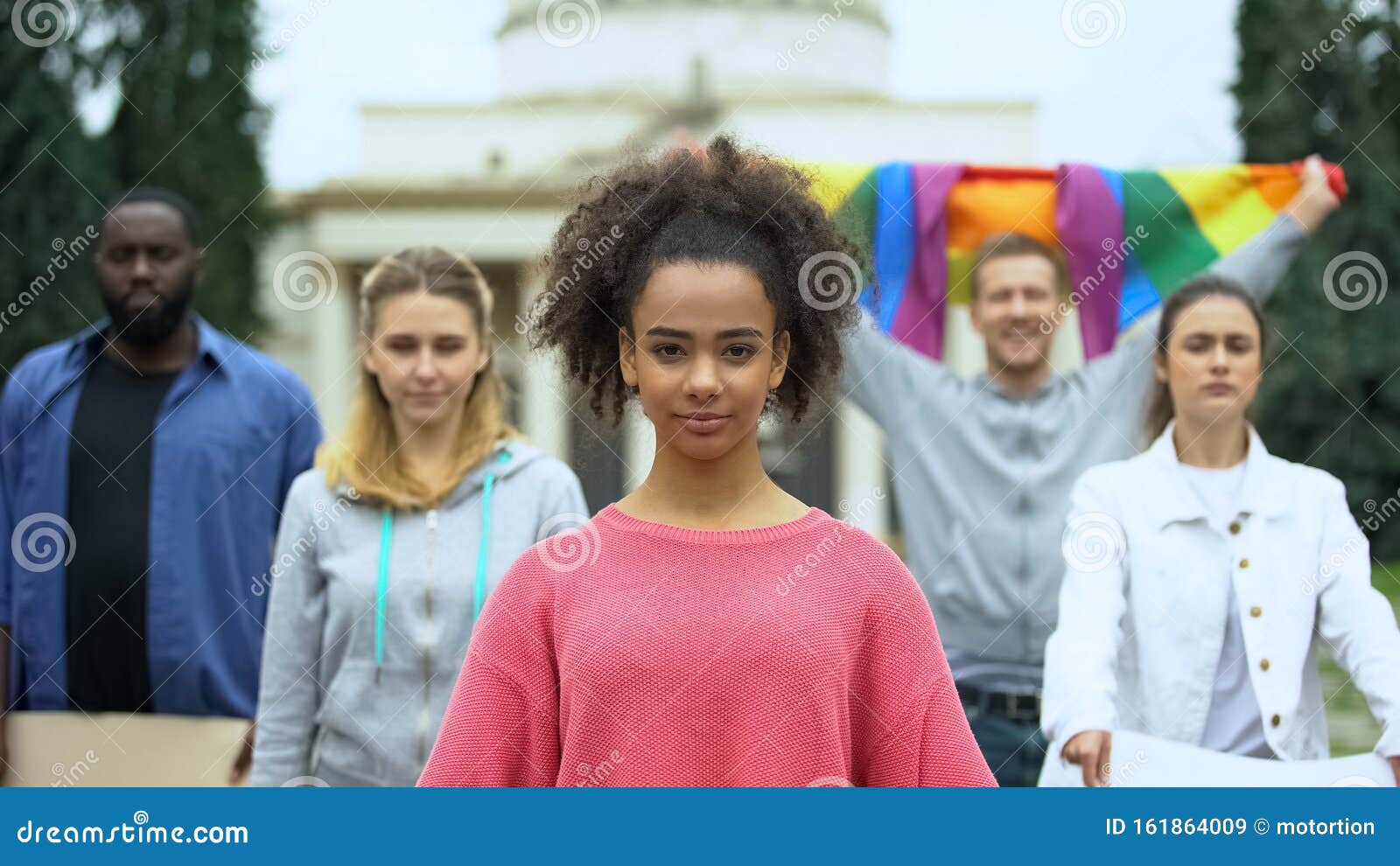 Activists Protesting Against Discrimination Holding Rainbow Flag, LGBT Community Stock Image