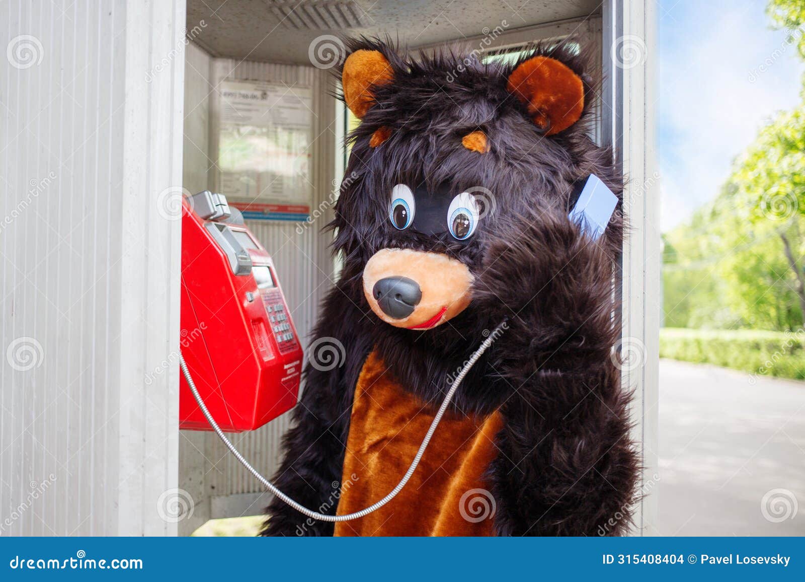actor dressed as bear talks on red public