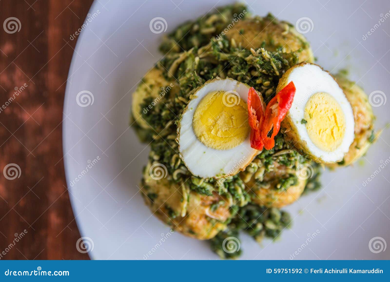 Adding Anchovy into Stirfry Egg and Green Chili Sauce Stock Photo