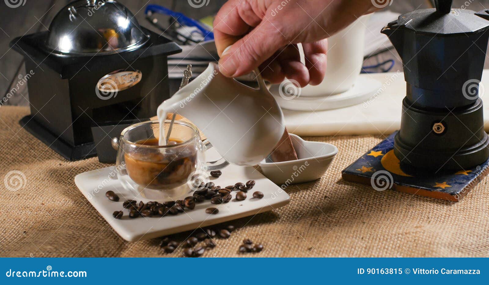 Adding Milk To a Cup of Coffee from a Traditional Italian Coffee