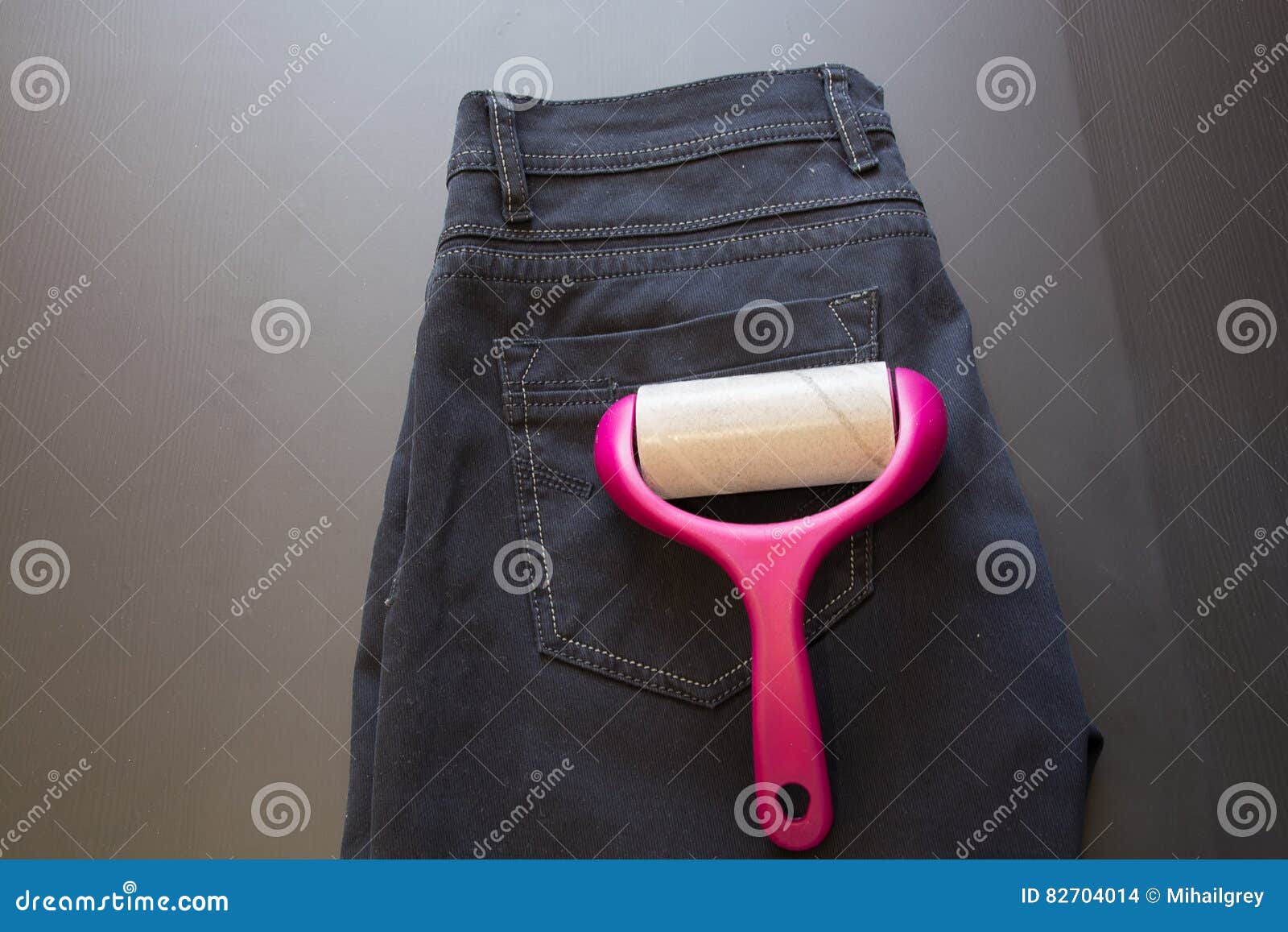 Adhesive Roller for Cleaning Cloth on a Pants. Stock Photo Image of