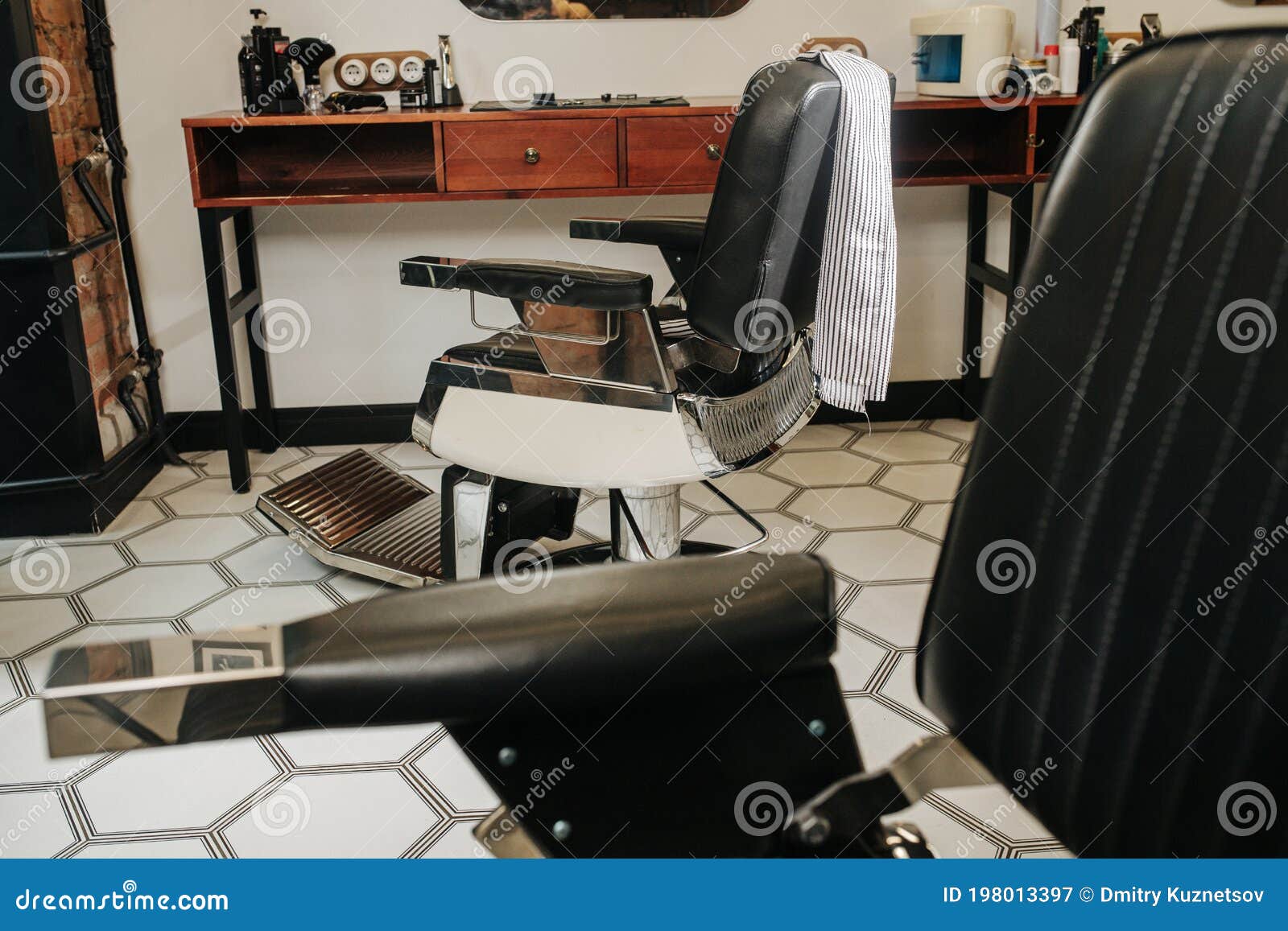 adjustable chairs set up in a barber shop on hexagonal-patterned floor