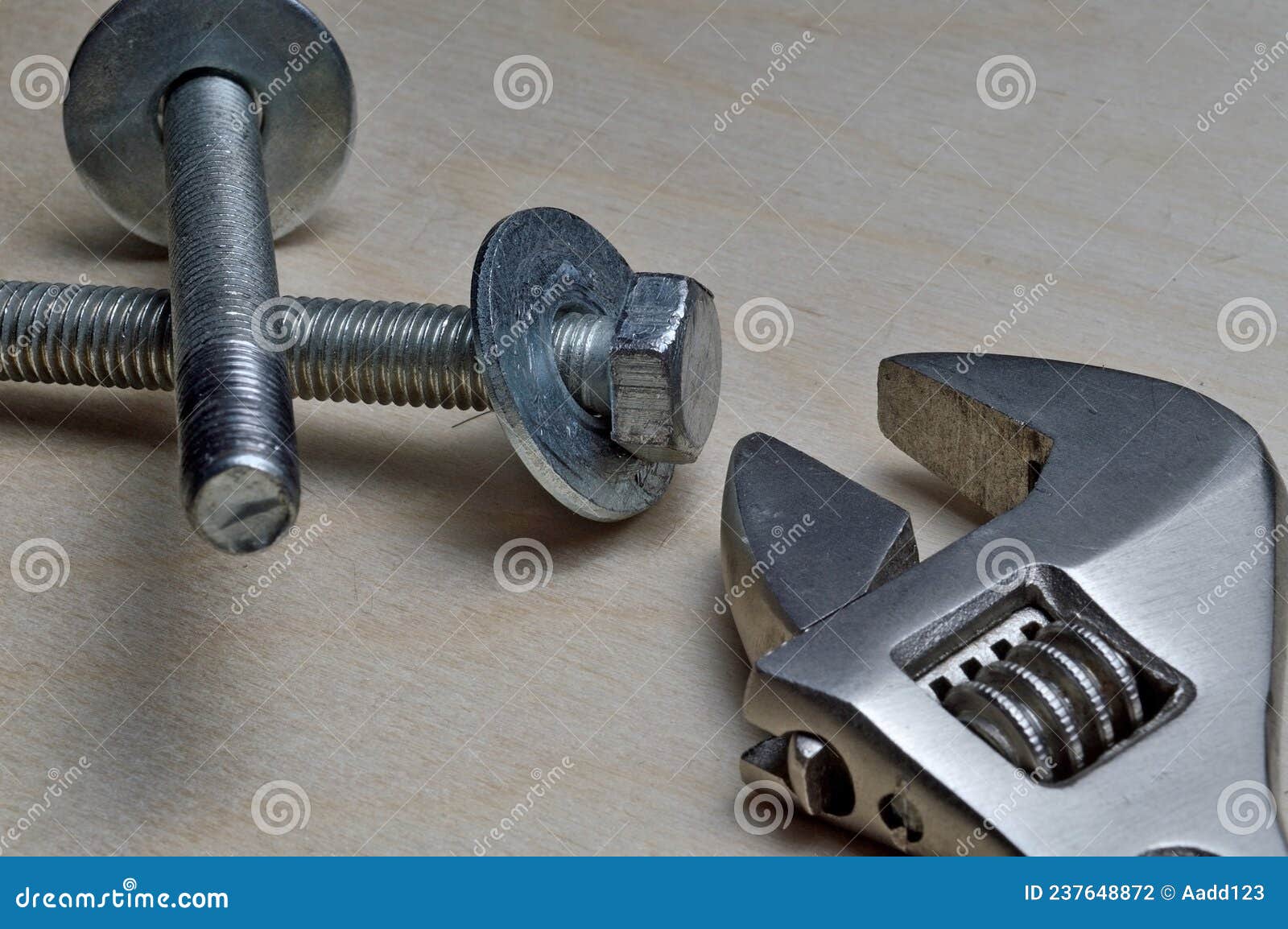 Adjustable Wrench with Metal Nut and Bolts. Closeup Stock Photo