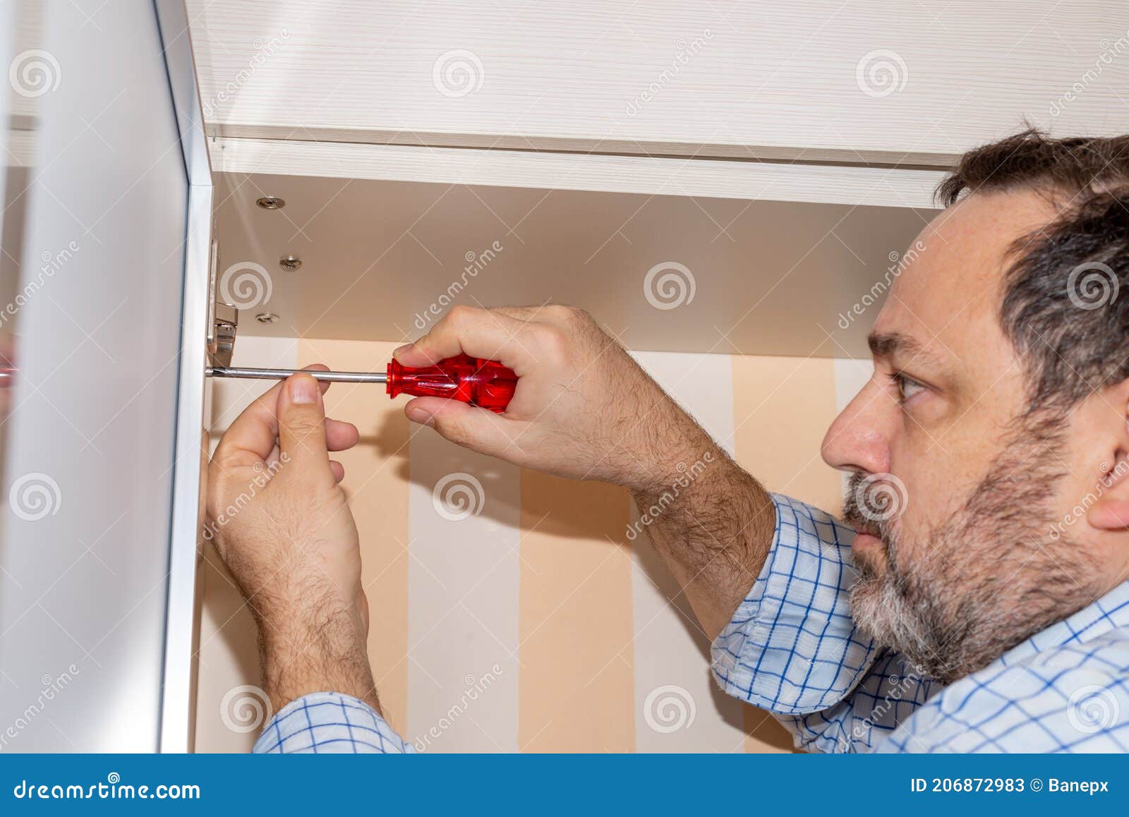 Adjusting a Hinge on a Wardrobe Door Stock Image Image of home