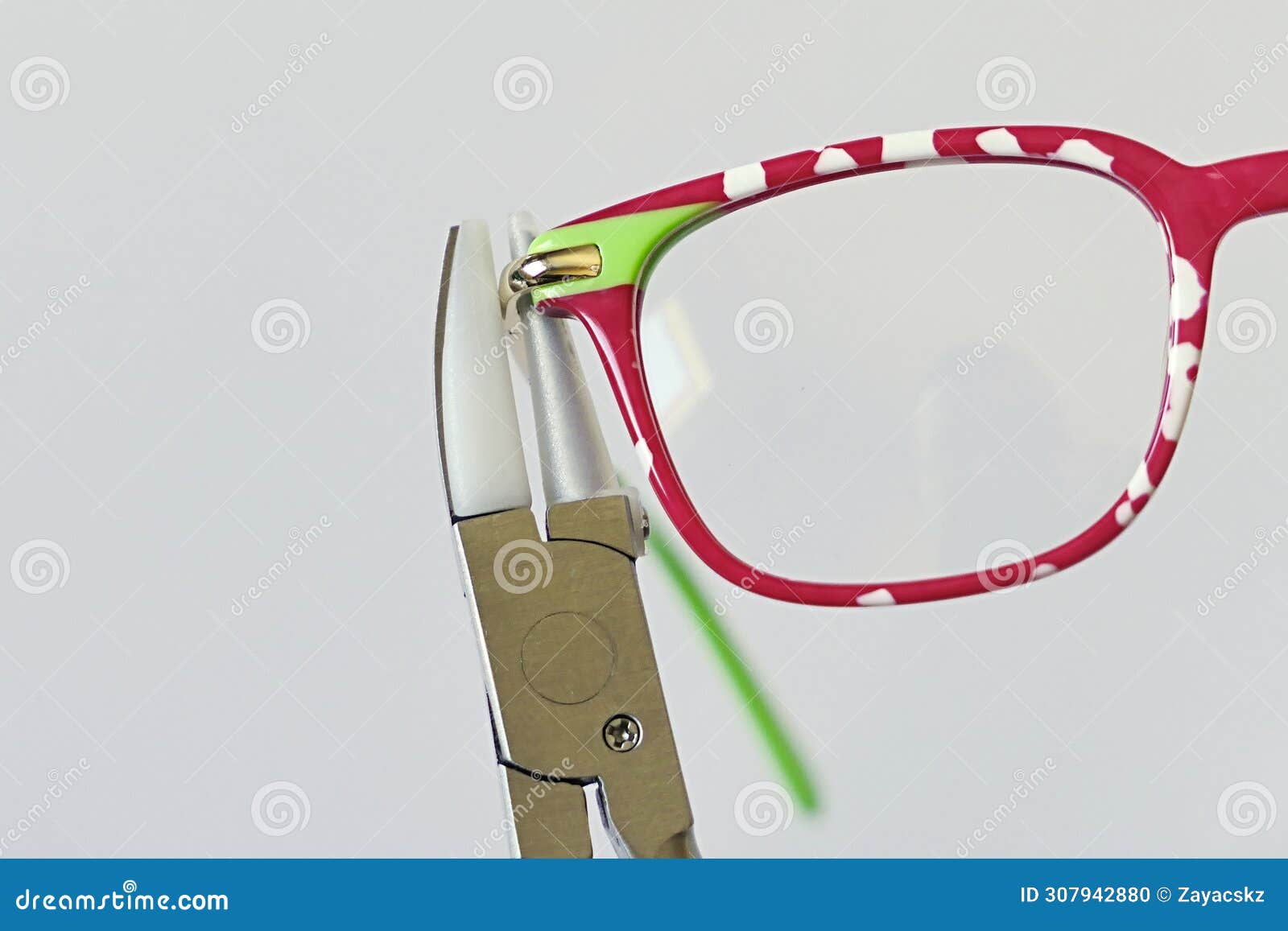 adjusting inclination on patchy red and white children eyeglass frame.