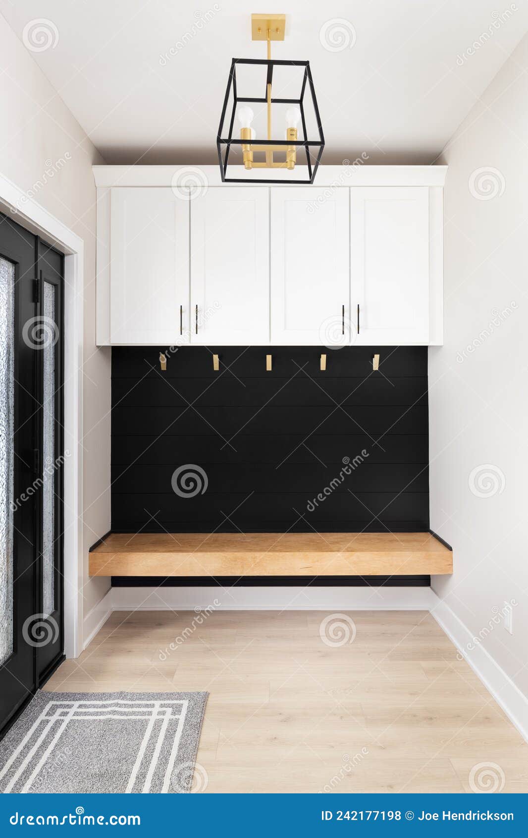 A Modern Farmhouse Entryway with a and Light Hanging Above