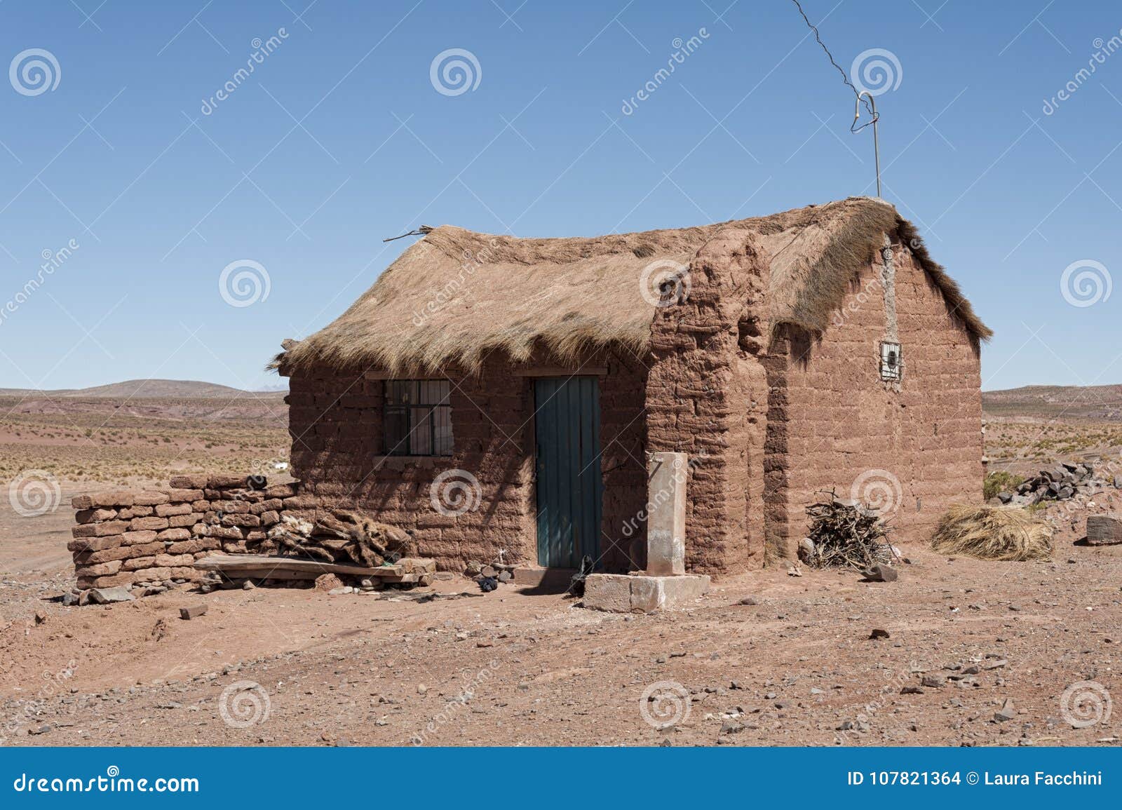 adobe house in cerrillos village on bolivian altiplano near eduardo avaroa andean fauna national reserve with blue sky, bolivia