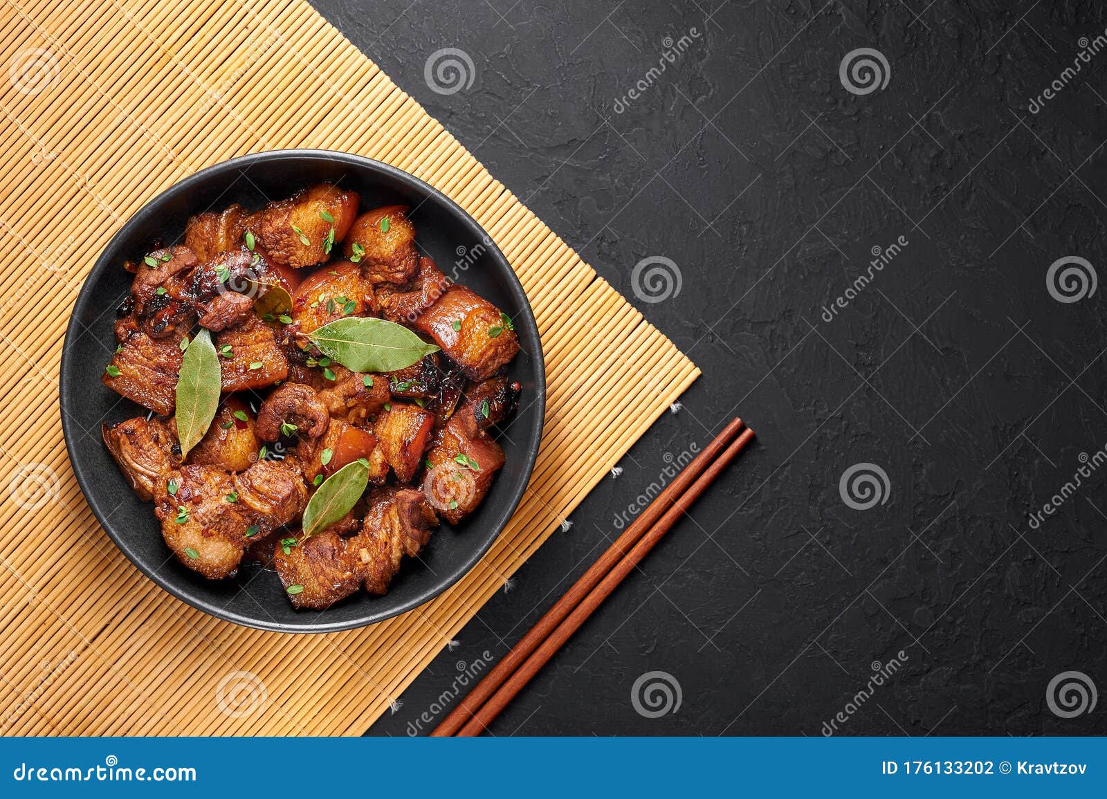 adobo pork in black bowl at dark slate background. pork adobo or adobong baboy is filipino cuisine dish. filipino food