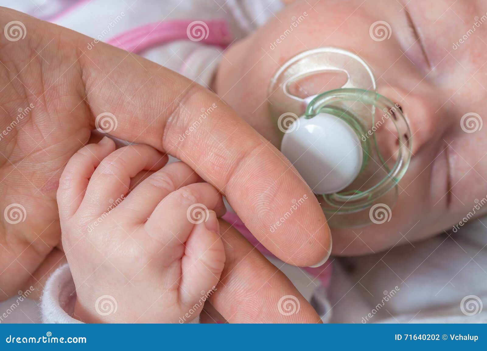 adoption baby concept. man is touching baby with hand