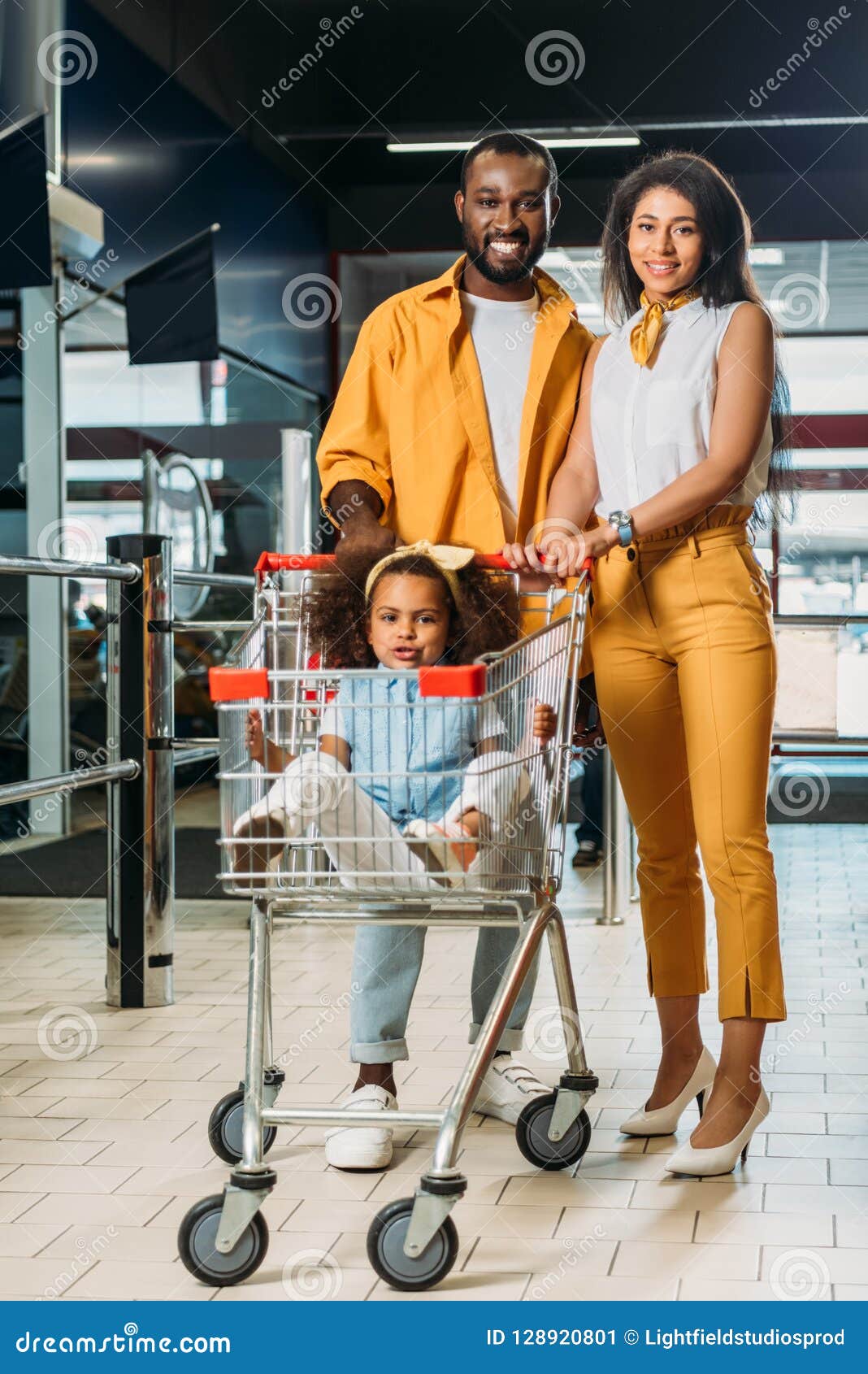 Adorable African American Kid Sitting in Shopping Trolley while Her ...