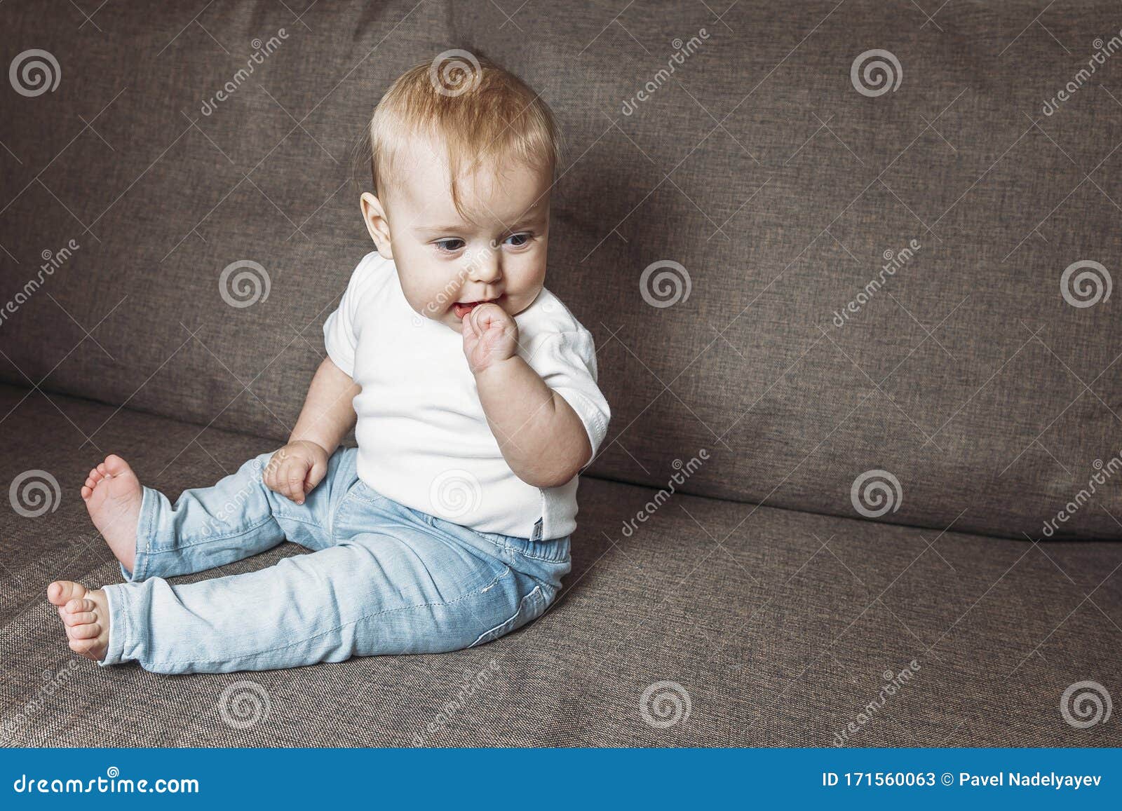 Baby Boy With Finger In The Mouth Stock Photo & More 