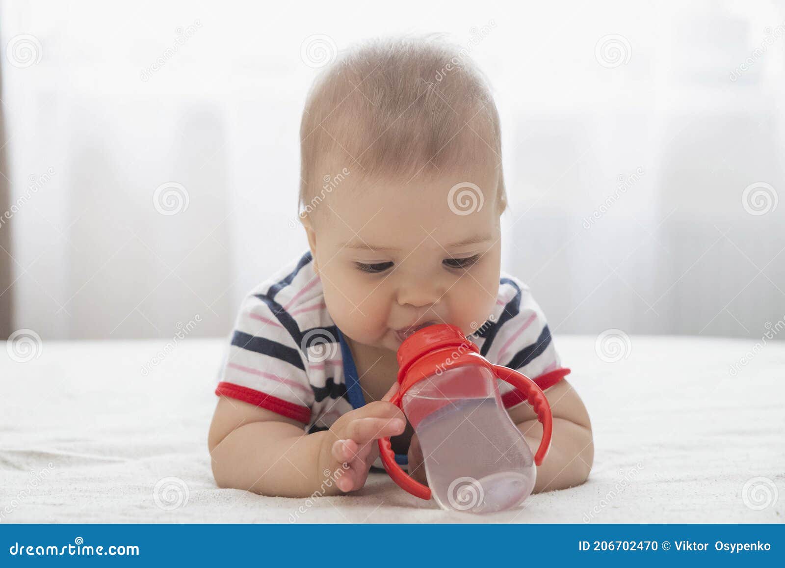 Adorable Baby Drinking Water Lying on the Bed Stock Photo Image of