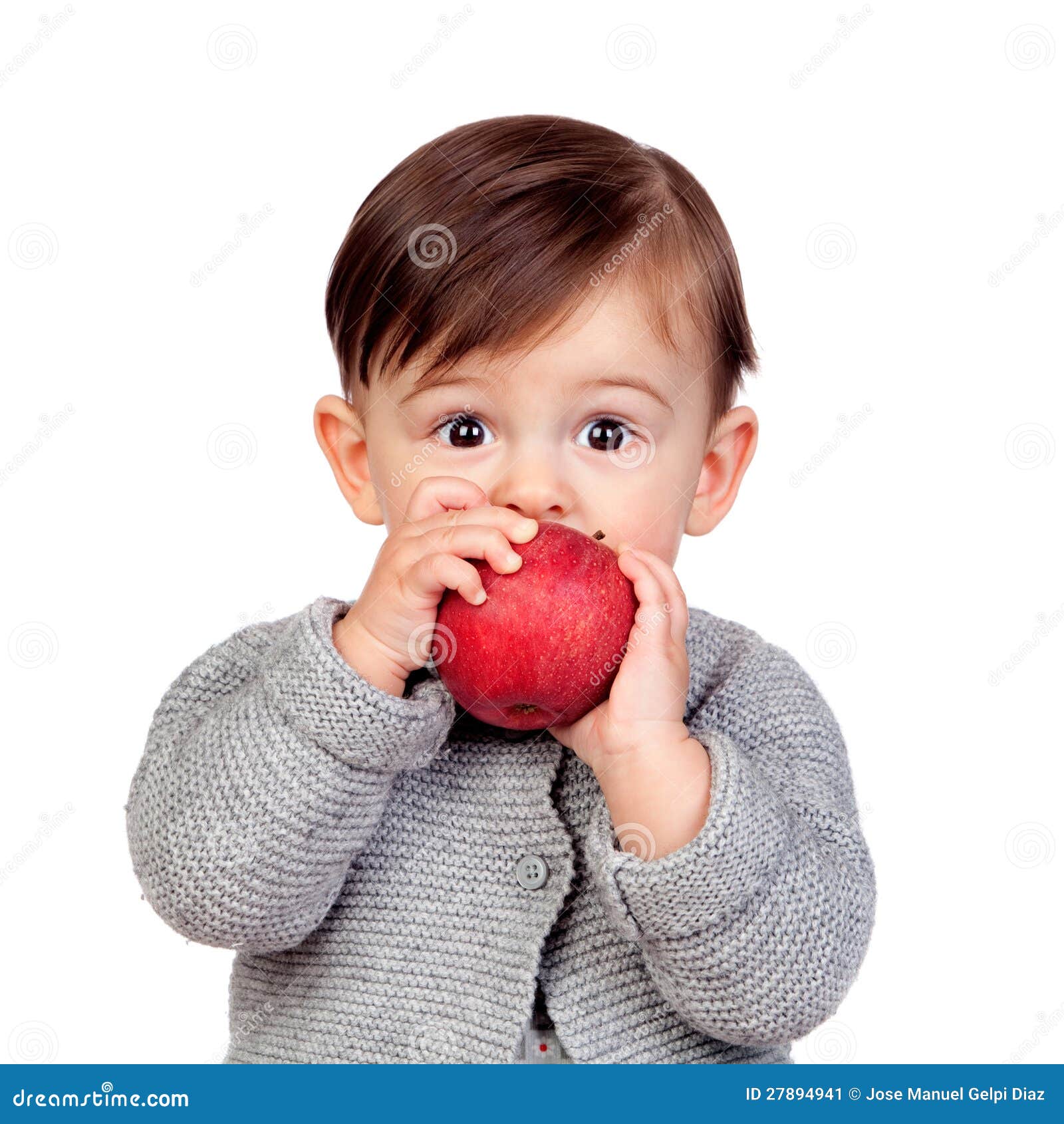 adorable baby girl eating a red apple