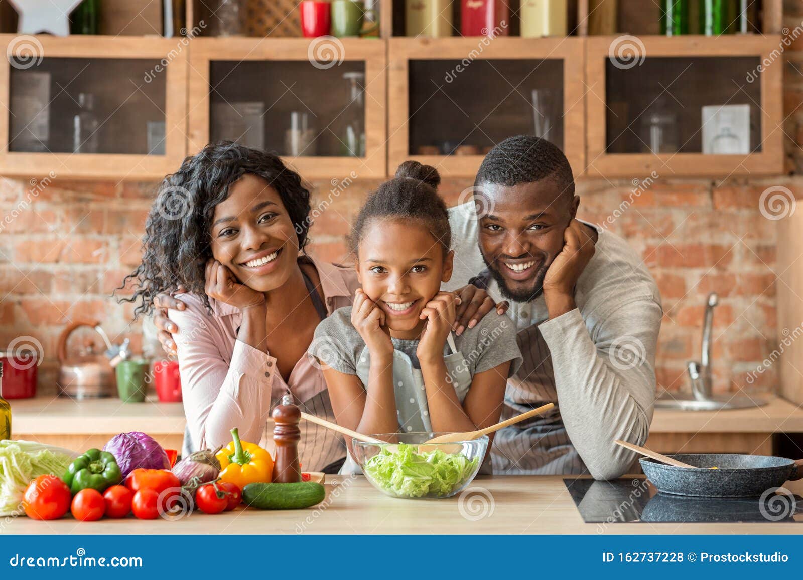 Adorable Black Family Cooking Healthy Dinner Together at Kitchen Stock