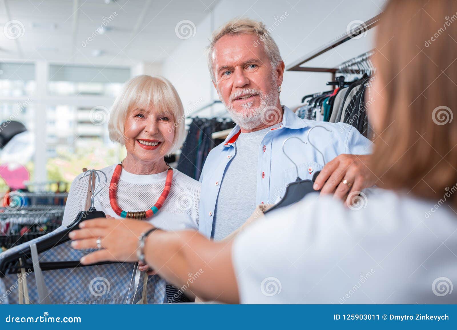 Adorable Elderly Couple In Front Of Cashier Desk Stock Image