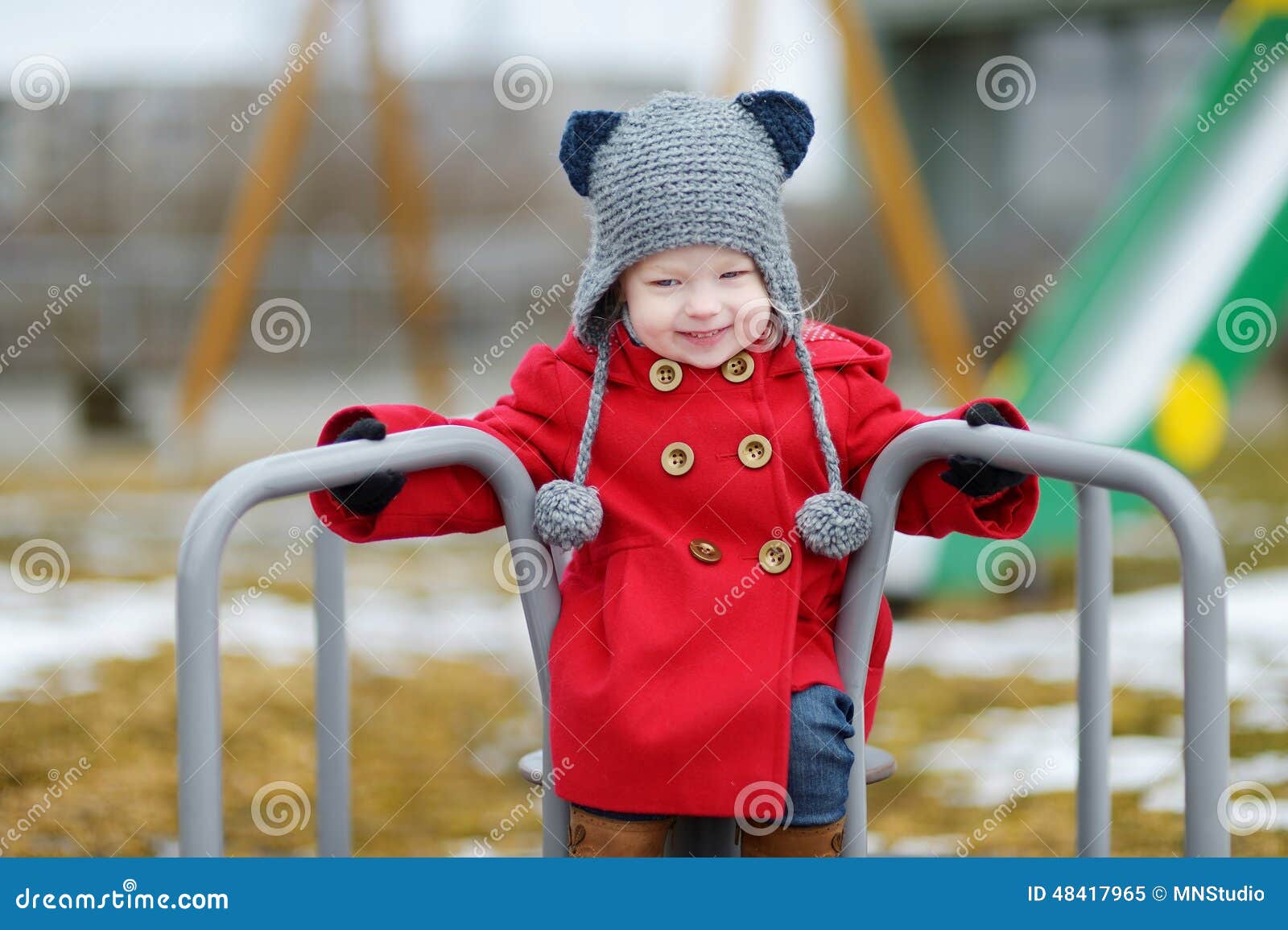 adorable girl having fun on a playgroud on spring