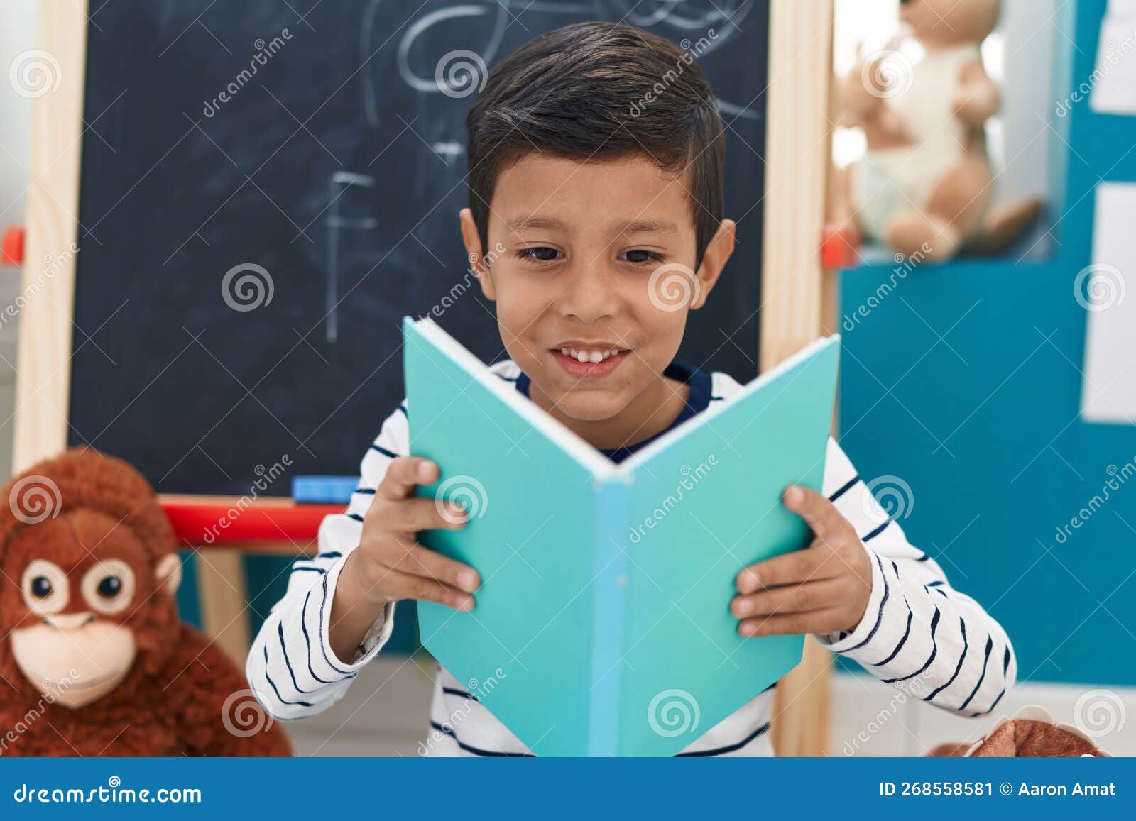 Adorable Hispanic Boy Student Smiling Confident Reading Book at