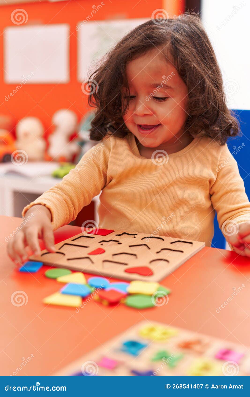 Adorable Hispanic Toddler Playing with Maths Puzzle Game Sitting on