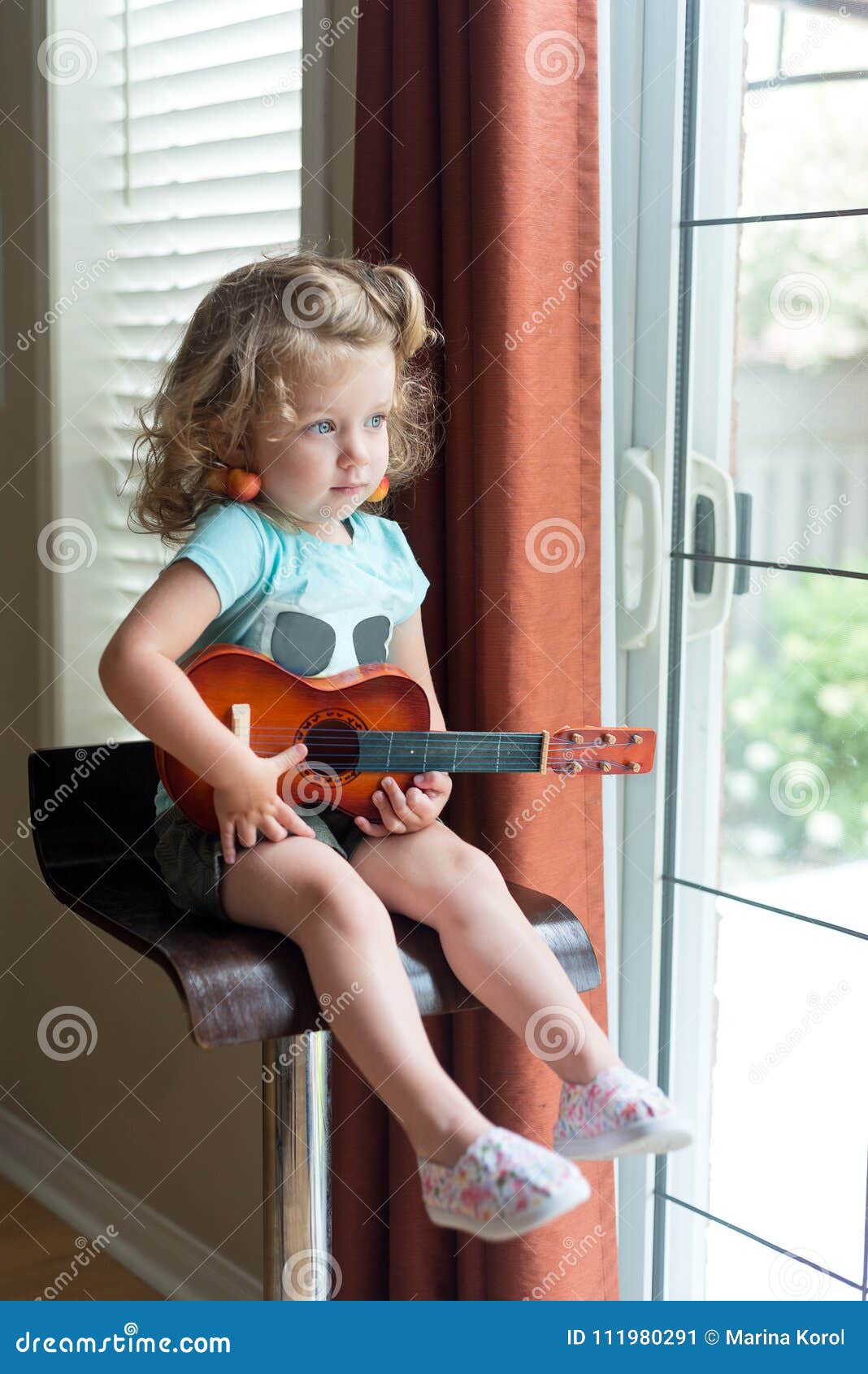Adorable Little Blonde Curly-hair Caucasian Toddler Girl with Blue Eyes is Holding an Ukulele Guitar, Sitting on the High Chair , Stock Image - Image of cherry, people: 111980291 Adorable Little Blonde Curly-hair Caucasian Toddler Girl with Blue Eyes is Holding an Ukulele Guitar, Sitting on the High Chair , Stock Image - Image of cherry, people: 111980291